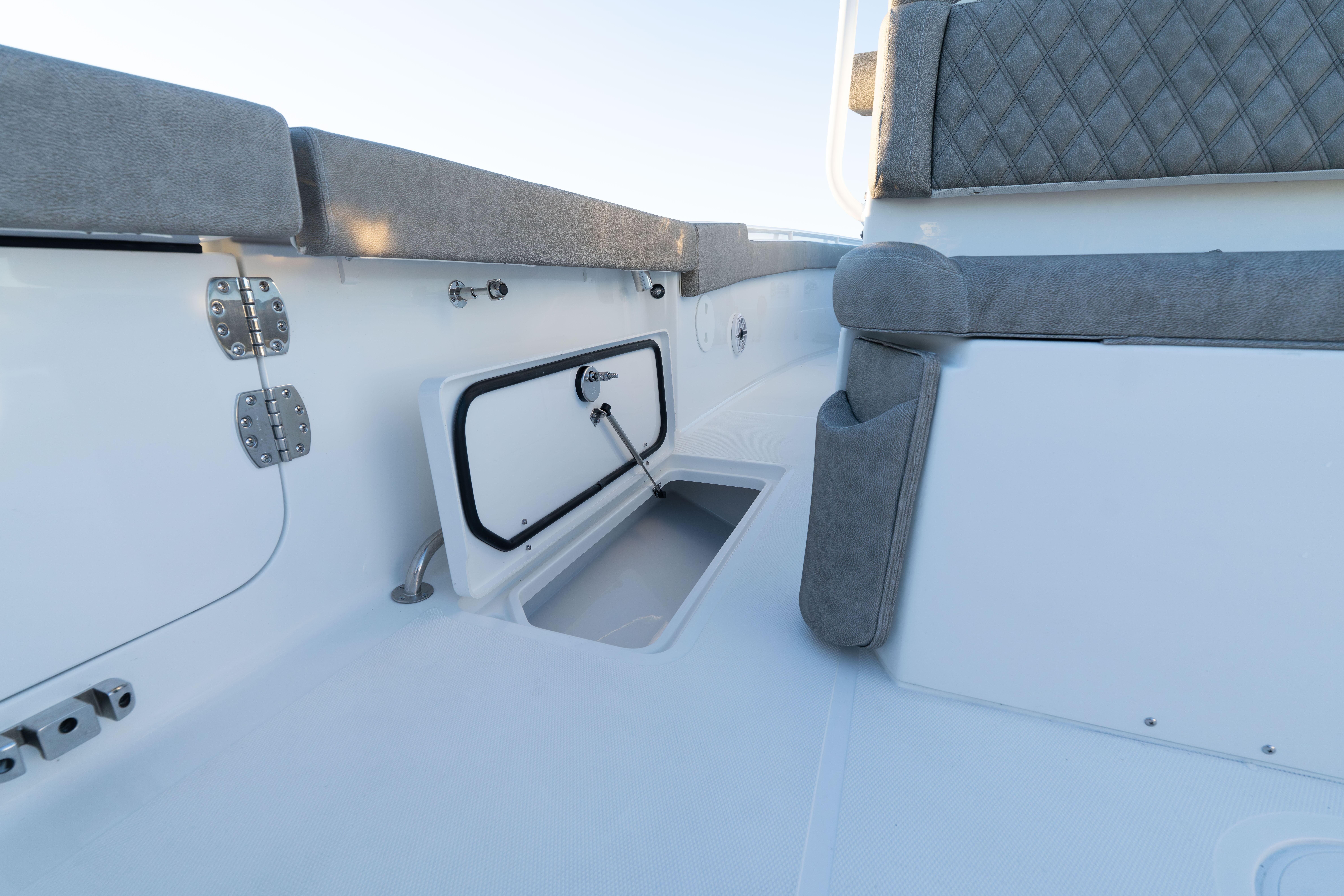 2026 Sea Hunt Ultra 275 Coffin Box boat interior with cushioned seating and storage compartment.