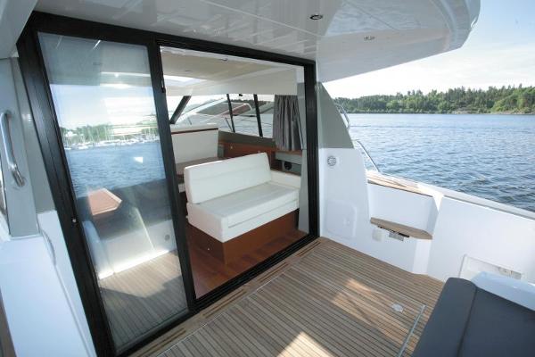 2017 Jeanneau NC 11 boat interior with sliding glass door and scenic water view.