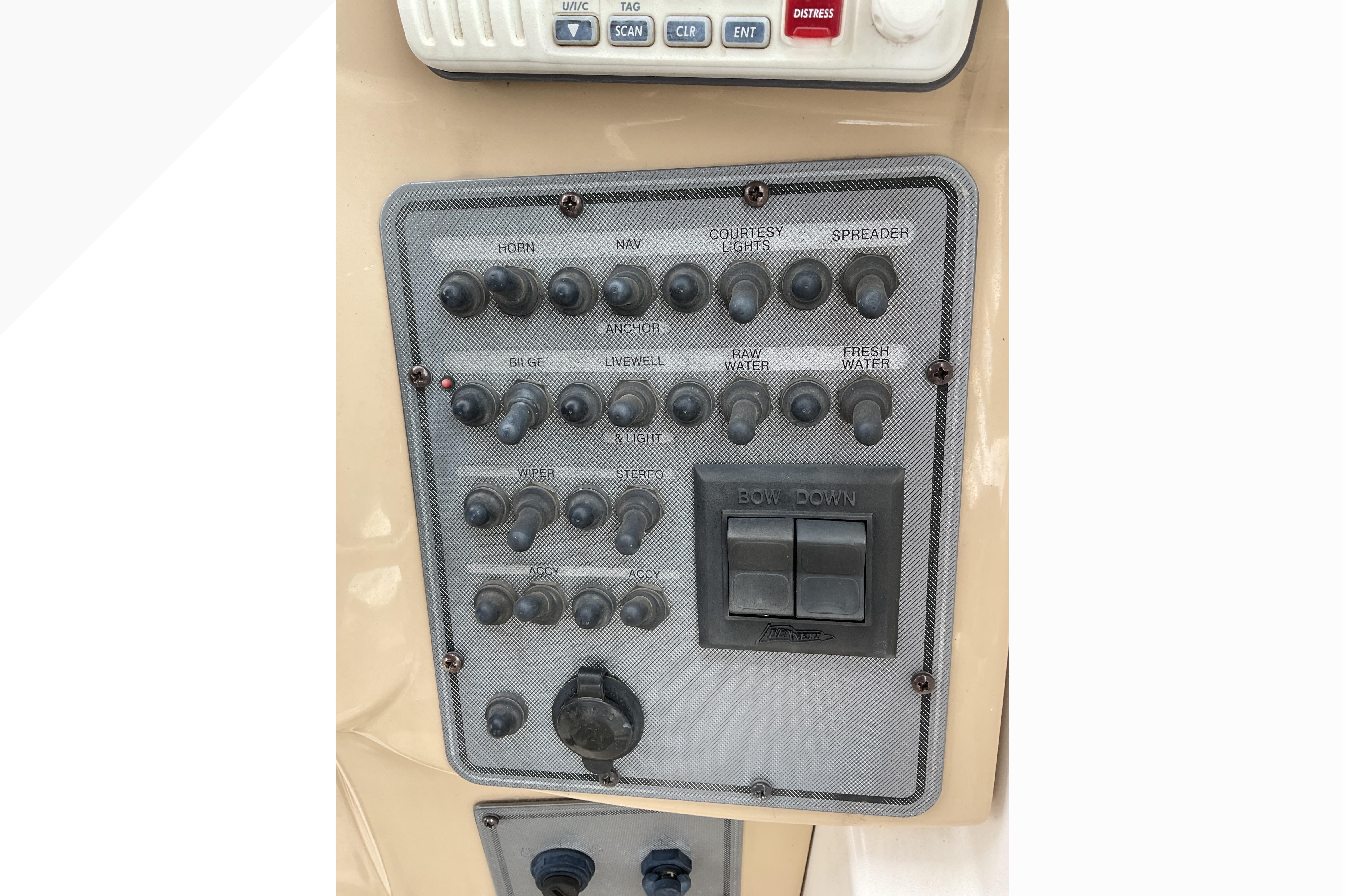 Control panel of a 2012 Wellcraft 232 Coastal boat with labeled switches and buttons.
