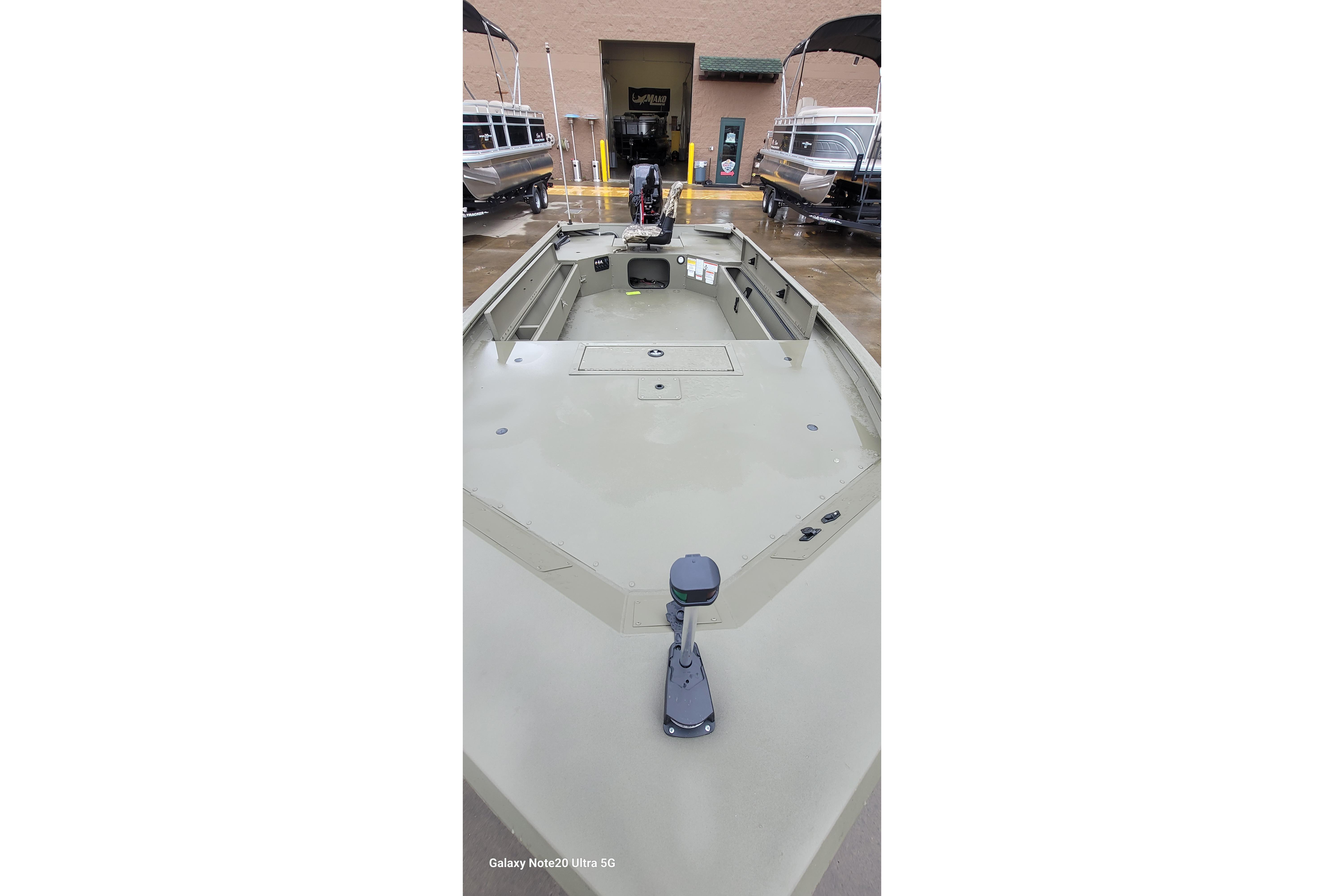 2026 Tracker Grizzly 1654 T Sportsman boat, interior view, parked outdoors.