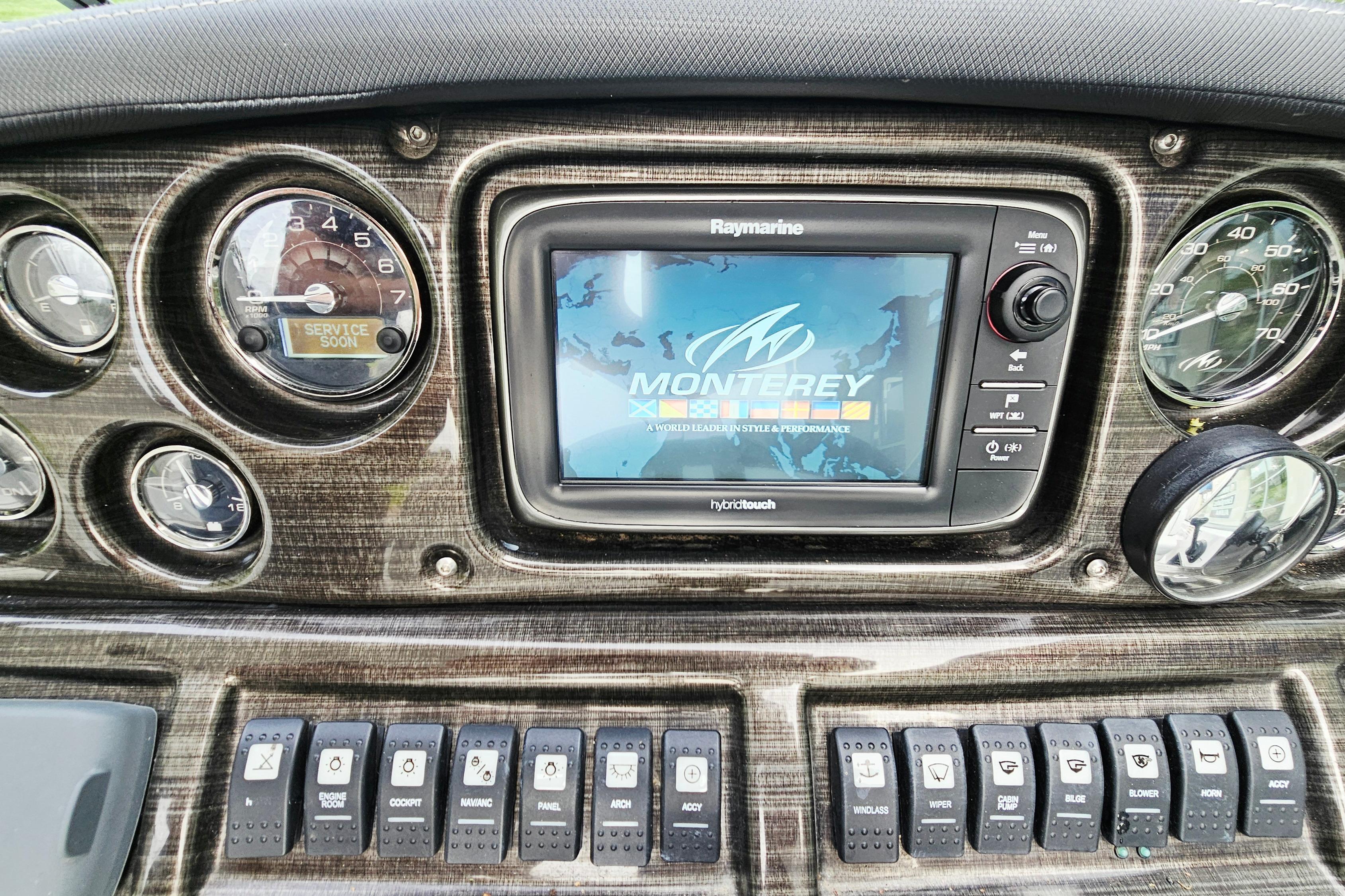 Dashboard of a 2016 Monterey 295 Sport Yacht with Raymarine display and control switches.