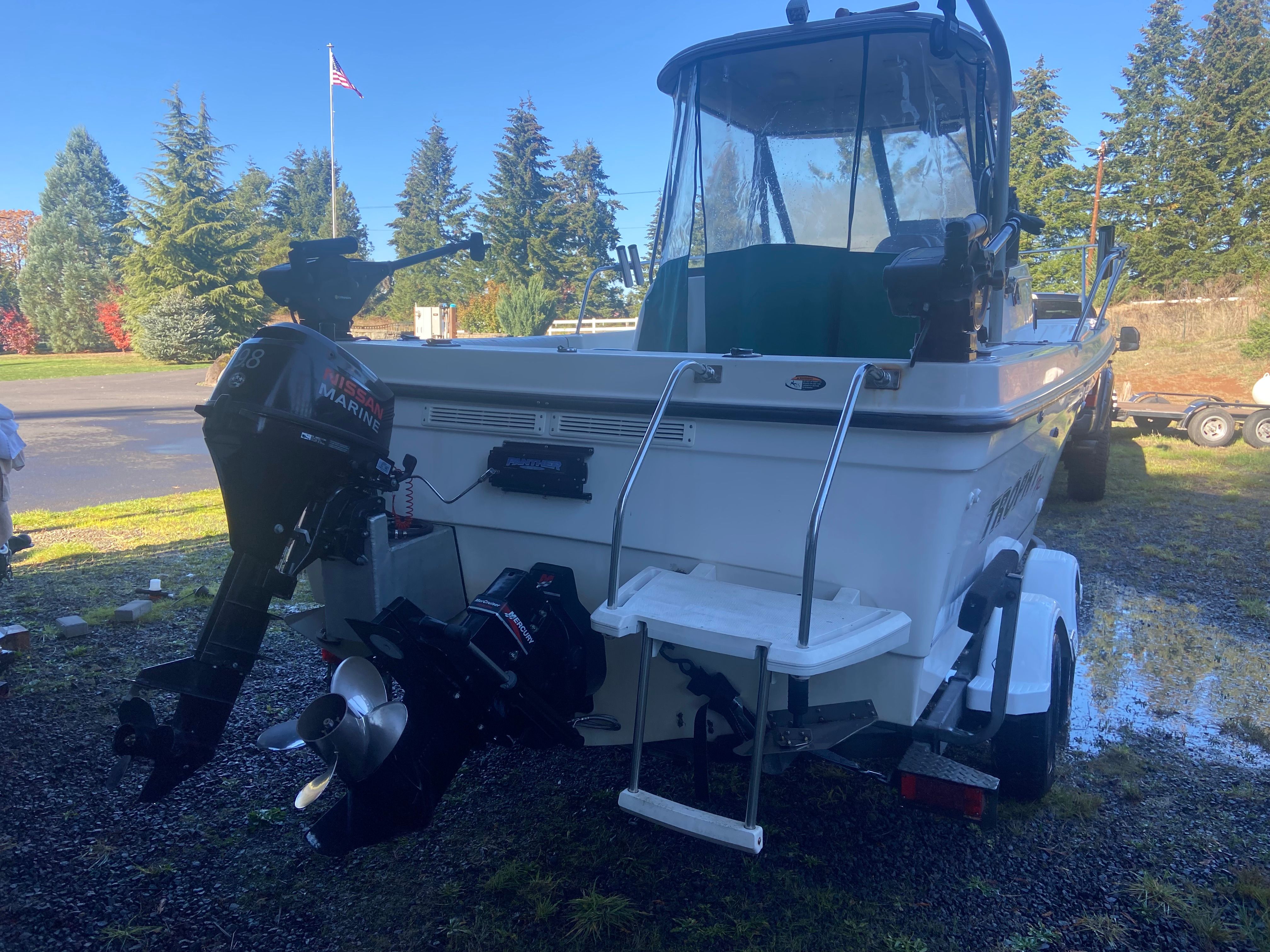 A 2003 Bayliner Trophy Pro 2052 WA on a trailer. The outboard motor is visible.