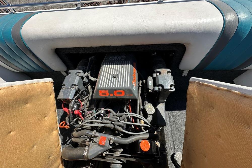 Engine compartment of a 1992 Reinell 192 RM boat with a 5.0-liter OMC engine.