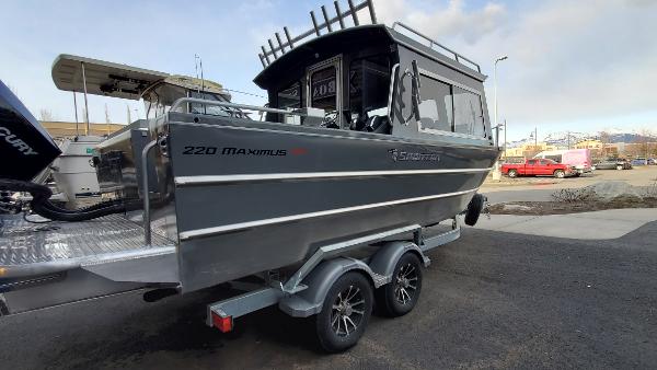 2023 Spartan 220 Maximus boat on trailer, sleek design, parked outdoors.