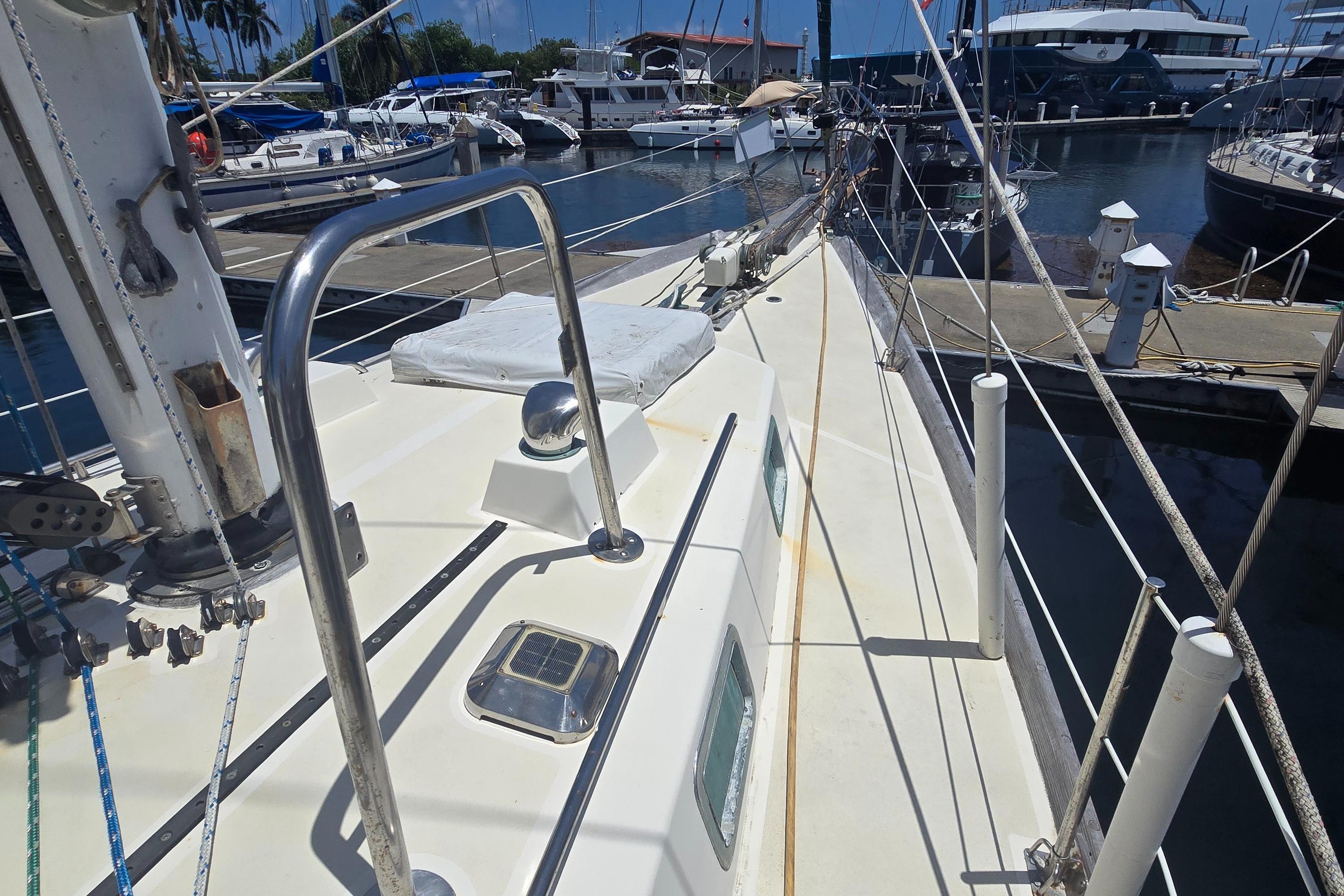 1978 Herreshoff 50 sailboat deck view at marina, showcasing rigging and docked boats.