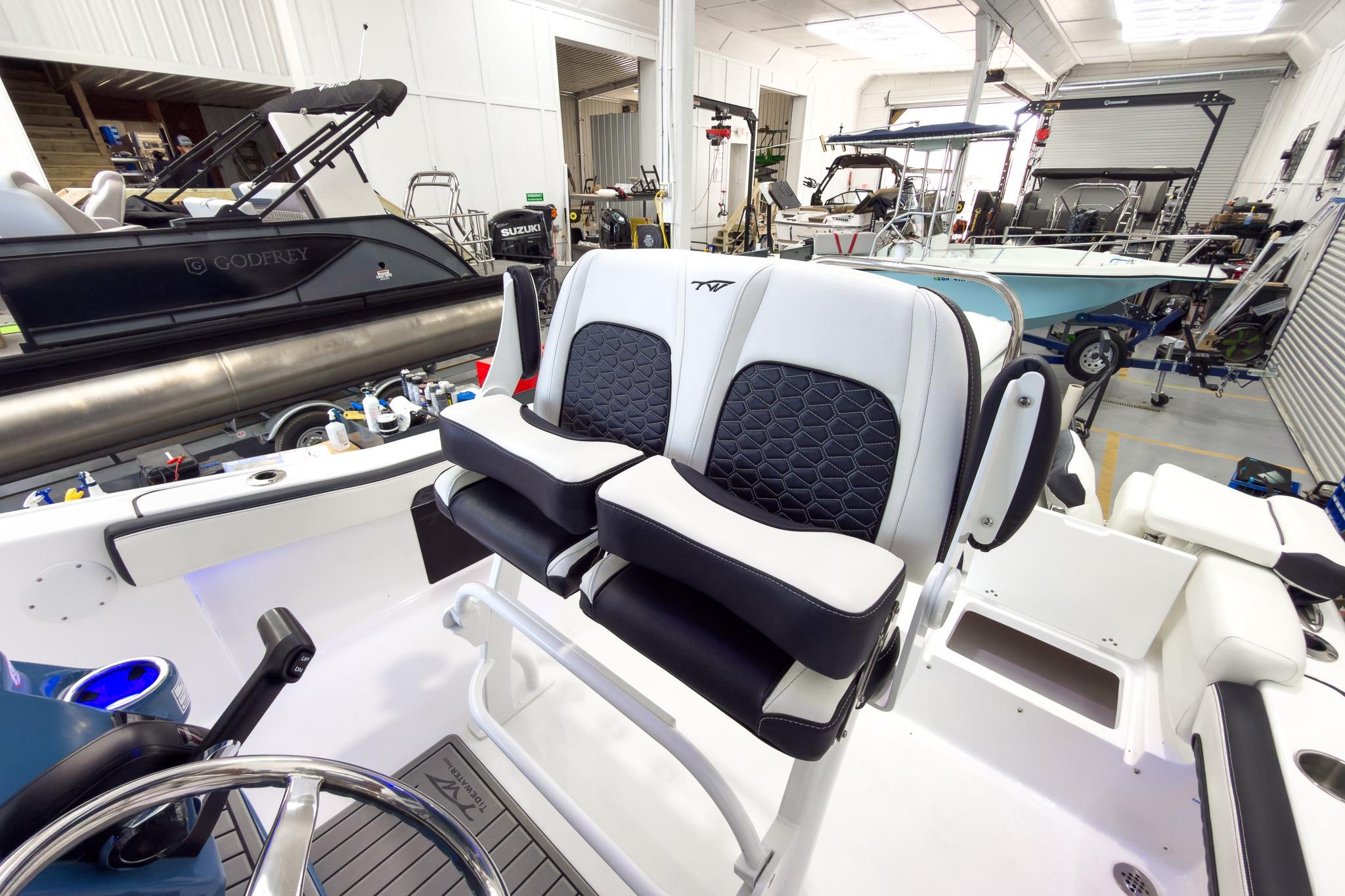The image shows the cockpit of a Tidewater 220 LXF boat in a workshop.