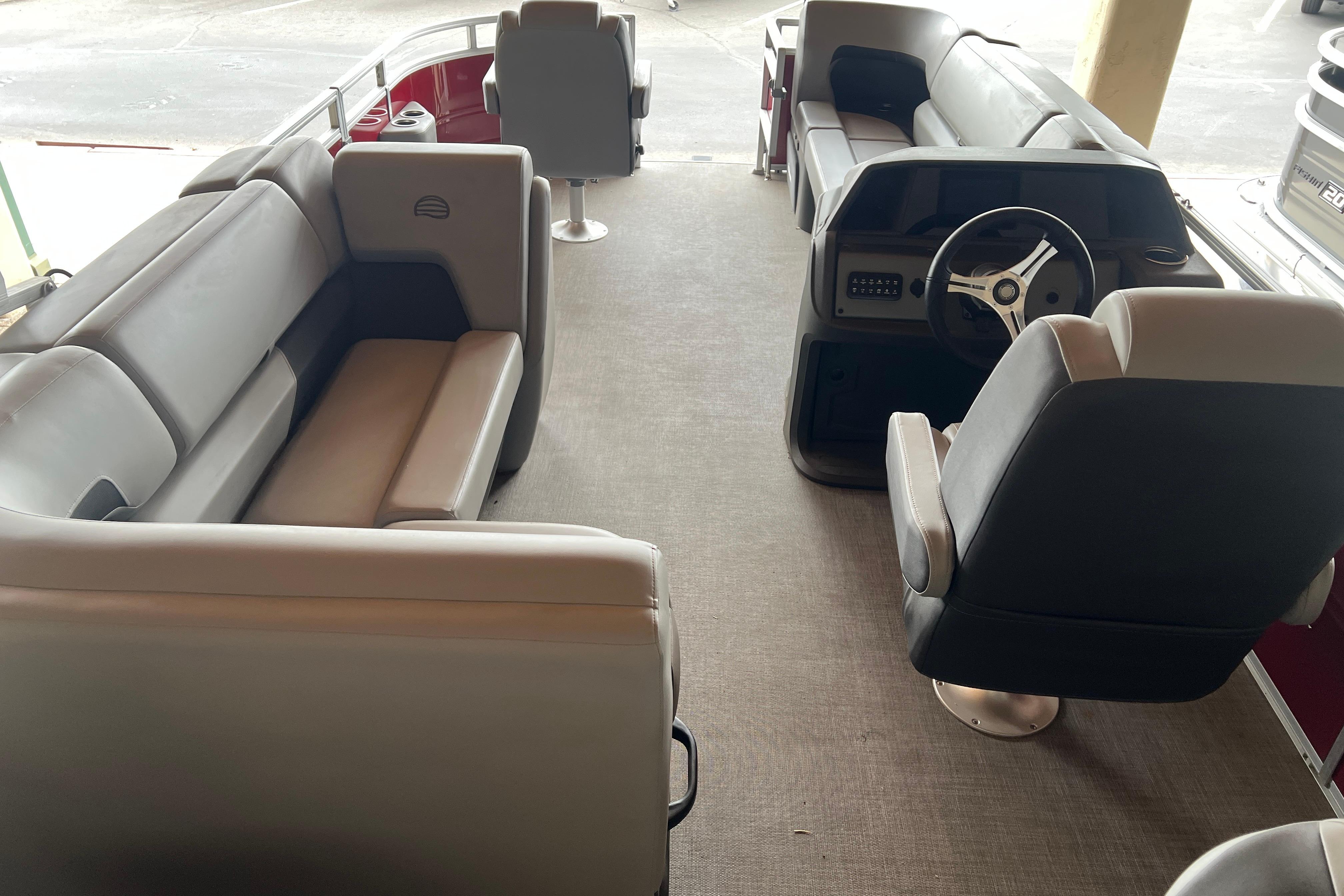 Interior of 2026 Sun Tracker SportFish 20 DLX pontoon boat with seating and steering console.