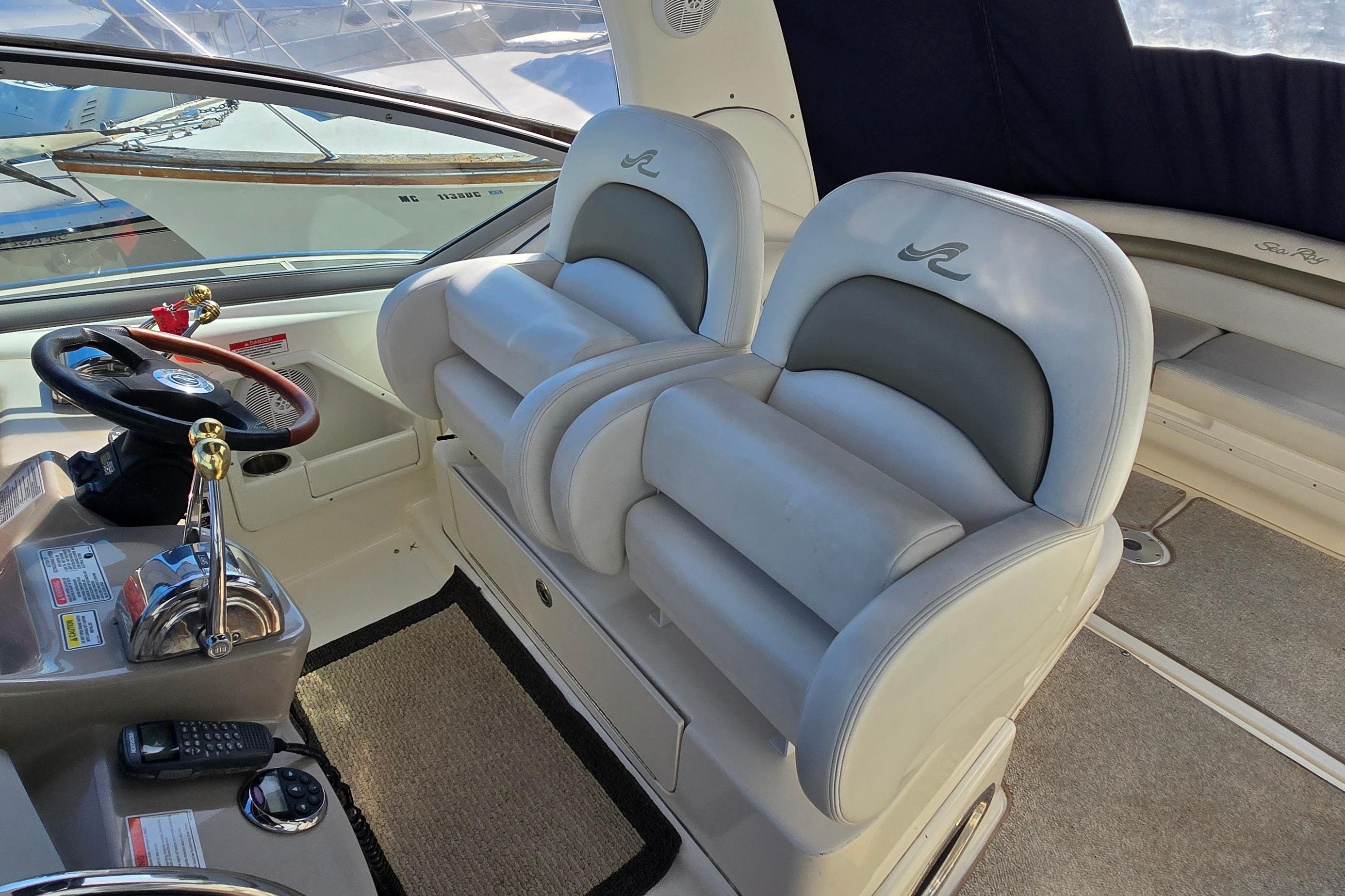Interior of 2007 Sea Ray 340 Sundancer boat with plush seating and helm controls.