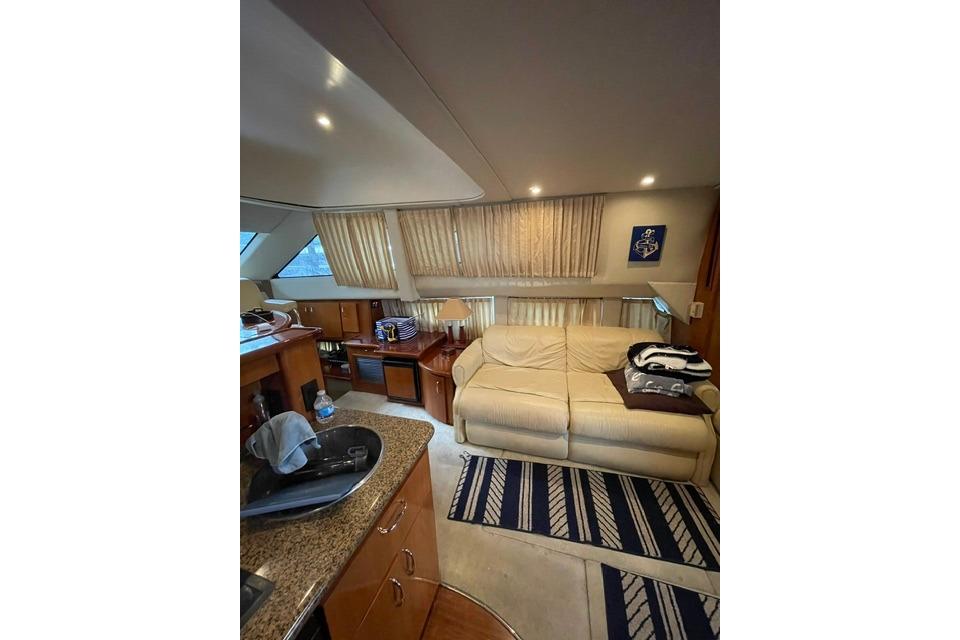Interior of 2003 Carver 36 Super Sport yacht with cozy seating and elegant decor.