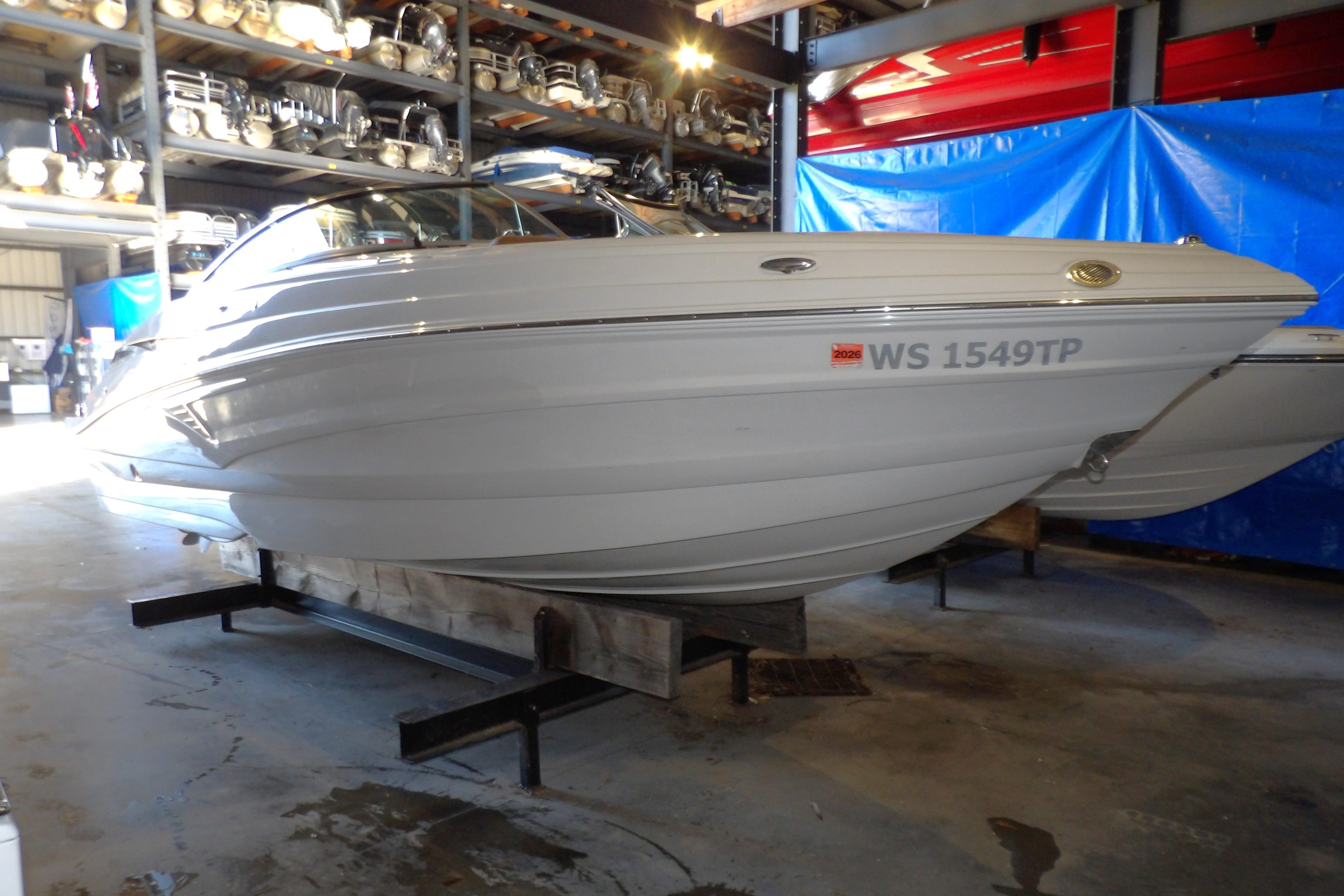 2023 Crownline 250 XSS boat in storage, side view, indoors.