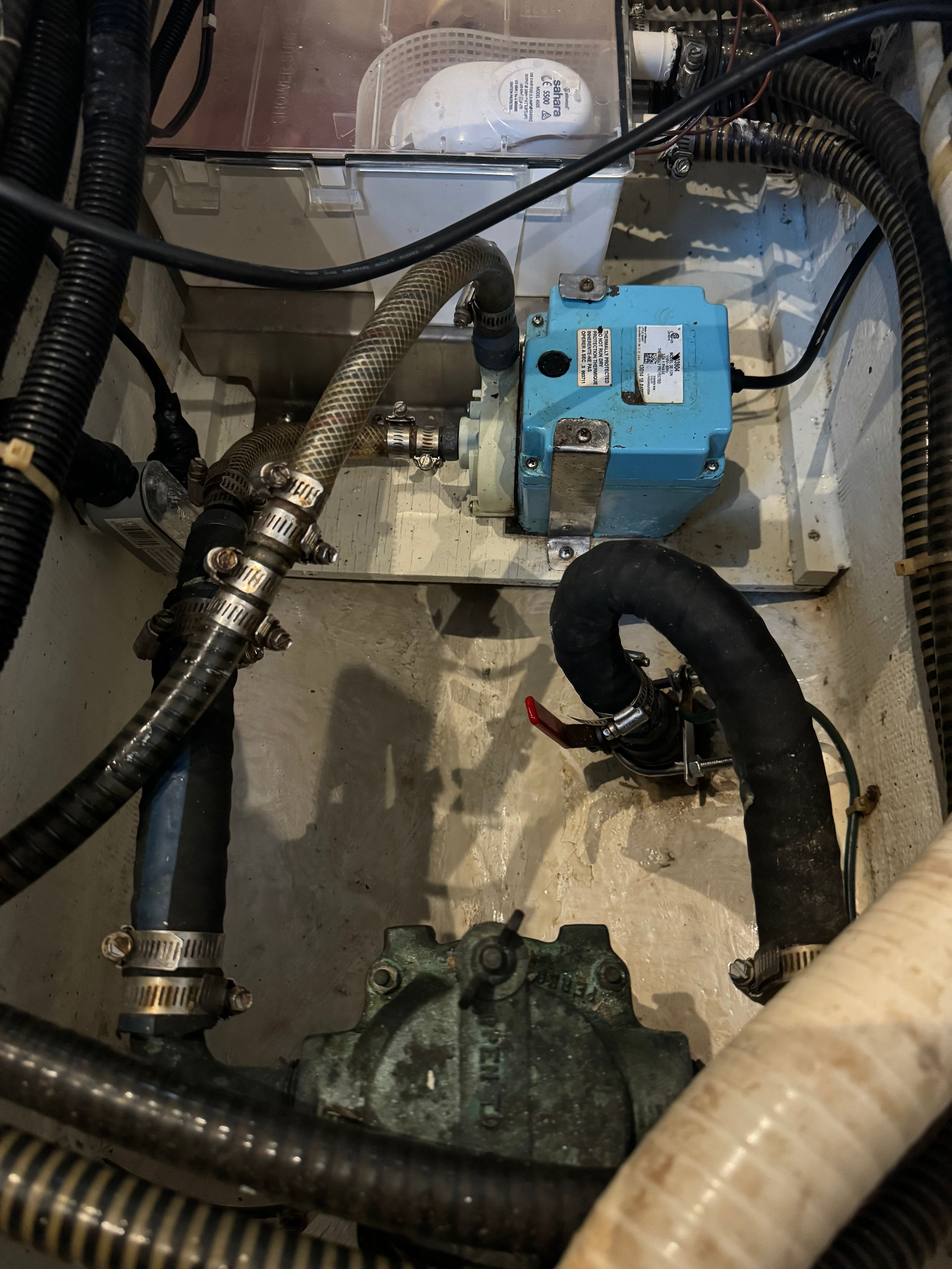 View of a 1995 Trojan 390x engine room with hoses and pumps.