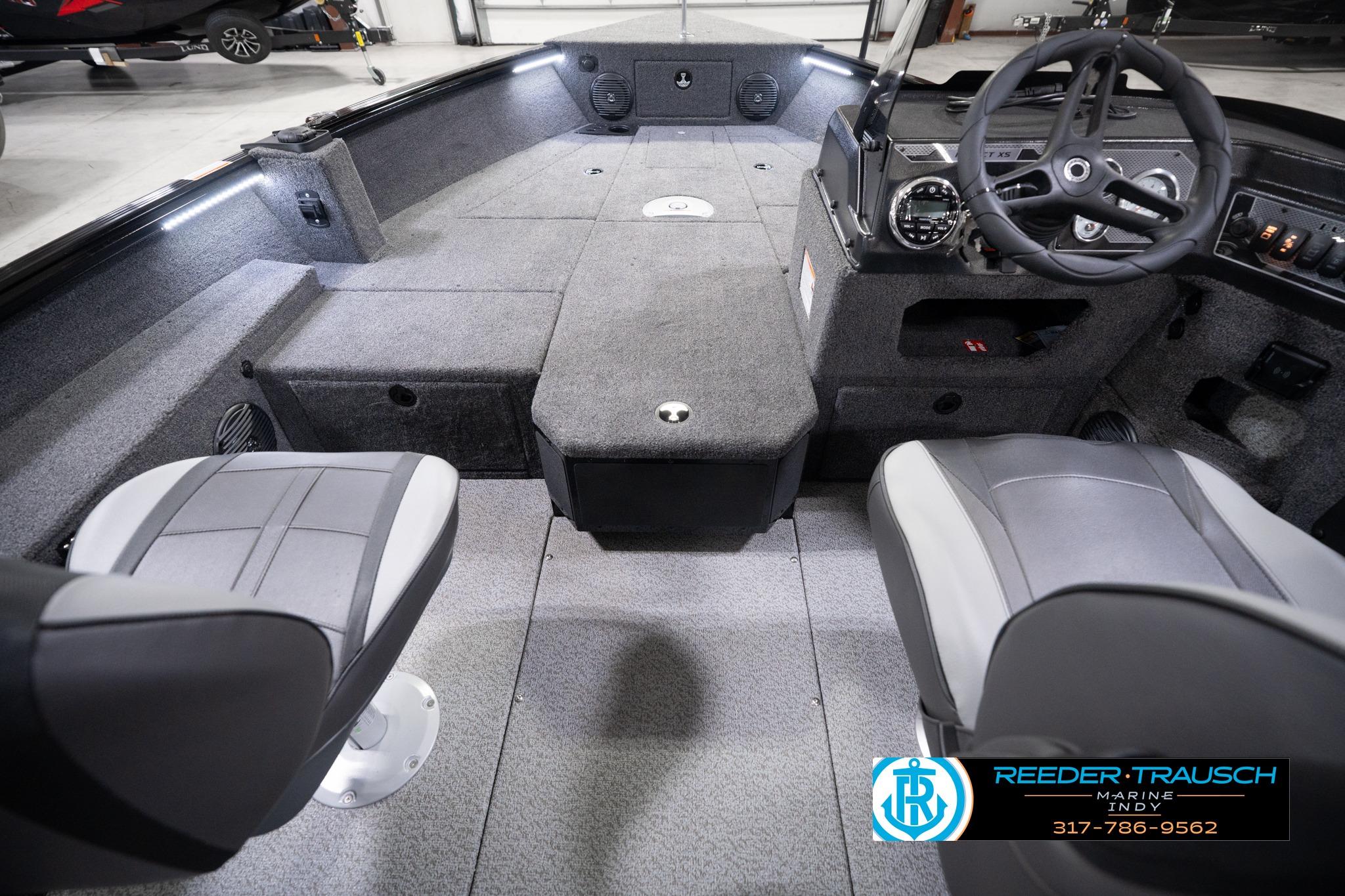 2026 Lund 1775 Impact XS SS boat interior with seating and steering console.