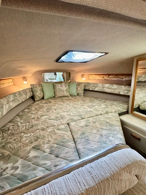 Interior of the 1992 Sea Ray 290 Sundancer with cozy sleeping area and skylights.