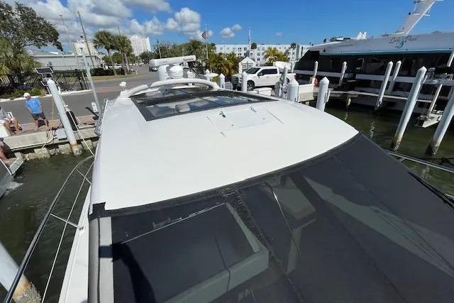 2016 Sea Ray Sundancer 510 yacht docked at marina under clear blue sky.