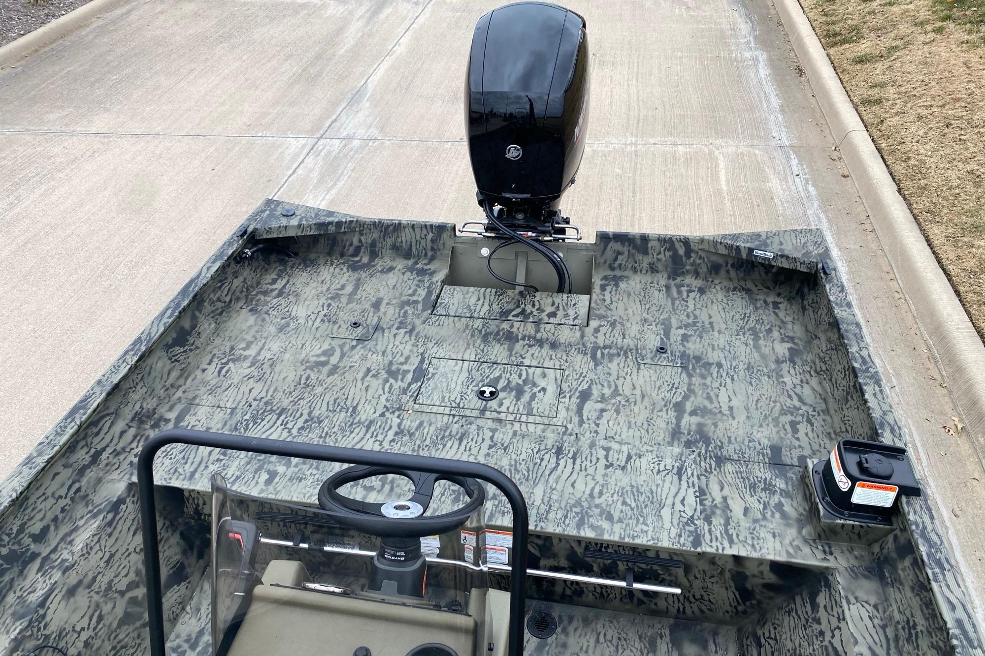 2026 Tracker Grizzly 2072 CC boat with camouflage design and outboard motor.