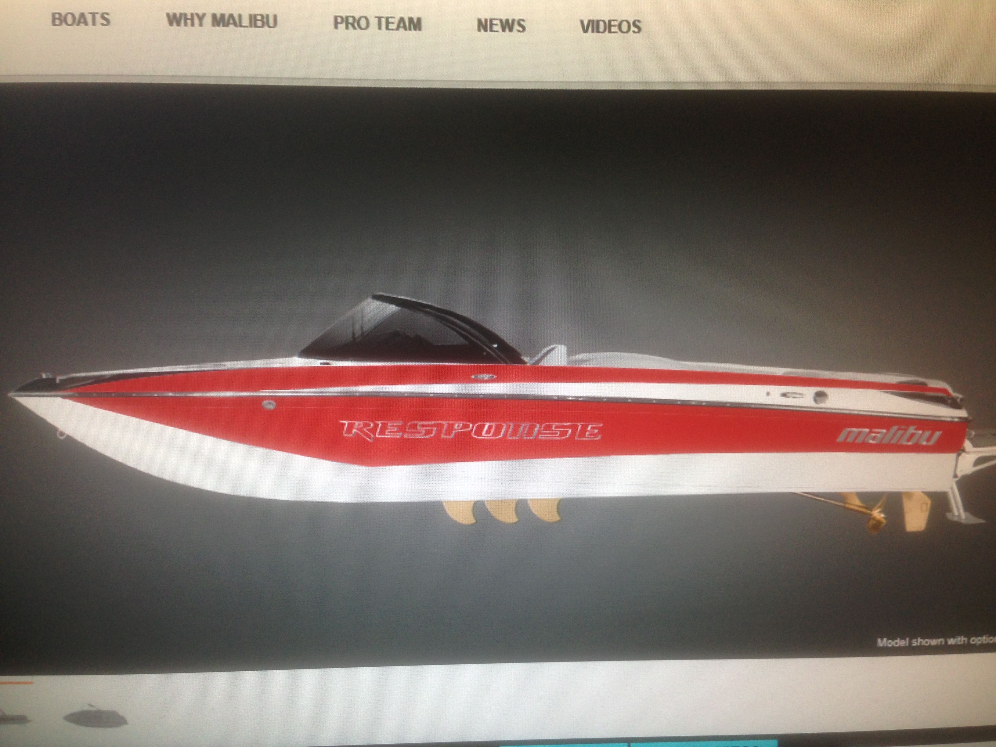 2014 Malibu Response TXi boat, red and white, side view.