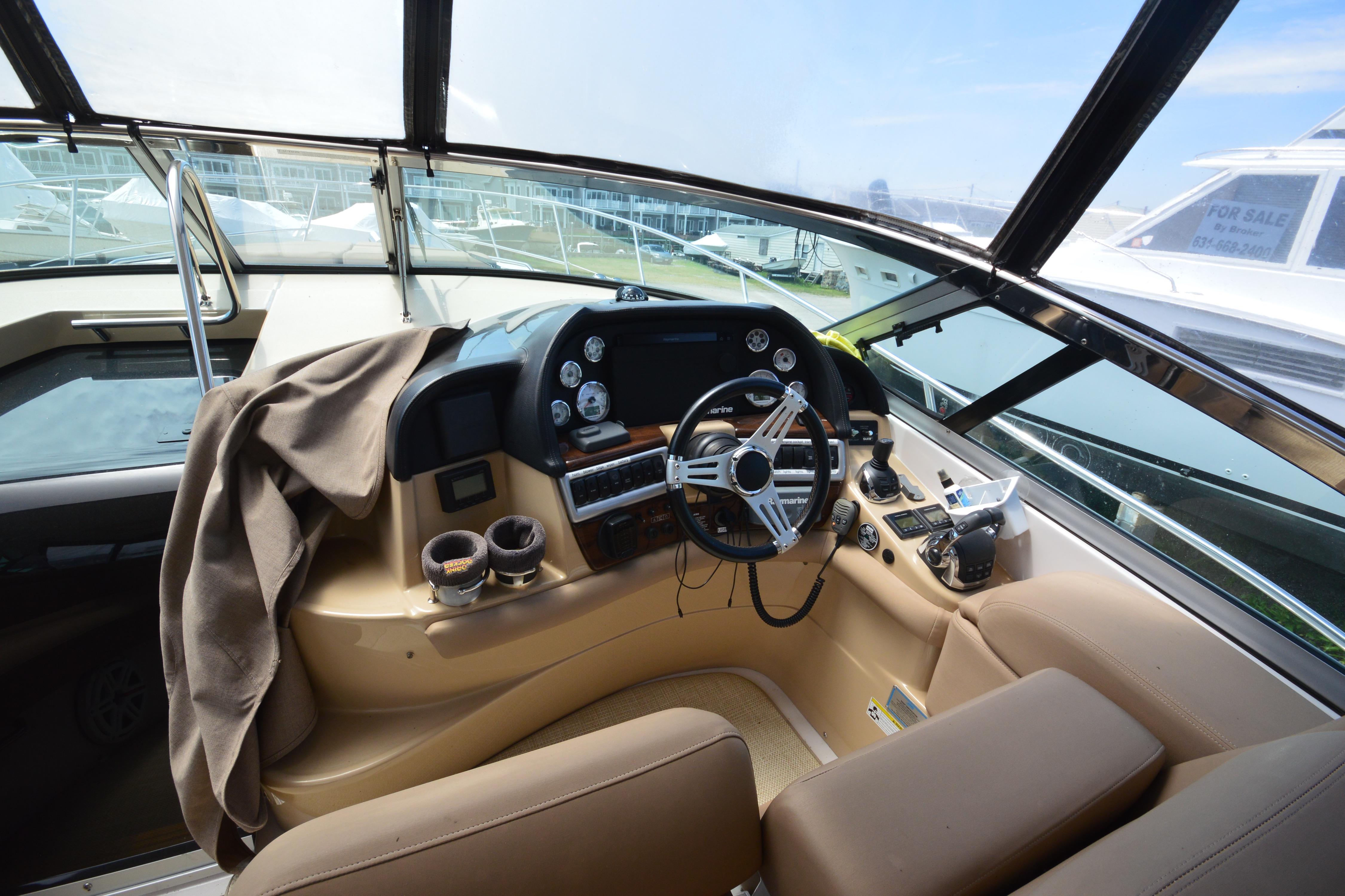 Interior cockpit of 2013 Four Winns V375 boat with steering wheel and controls.