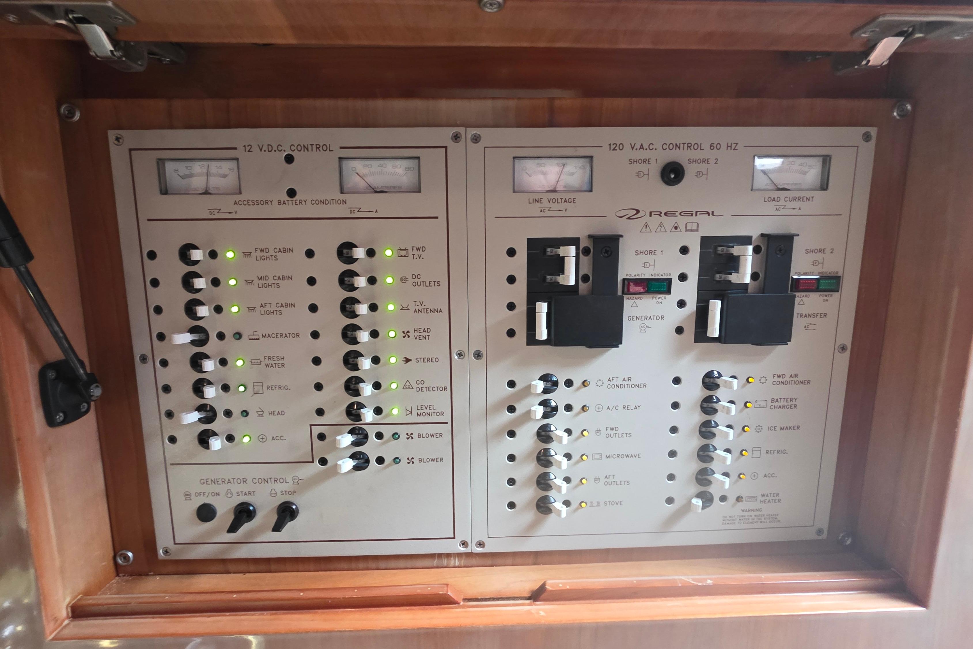 Electrical control panel of a 2002 Regal Commodore 4260 boat, featuring various switches and indicators.