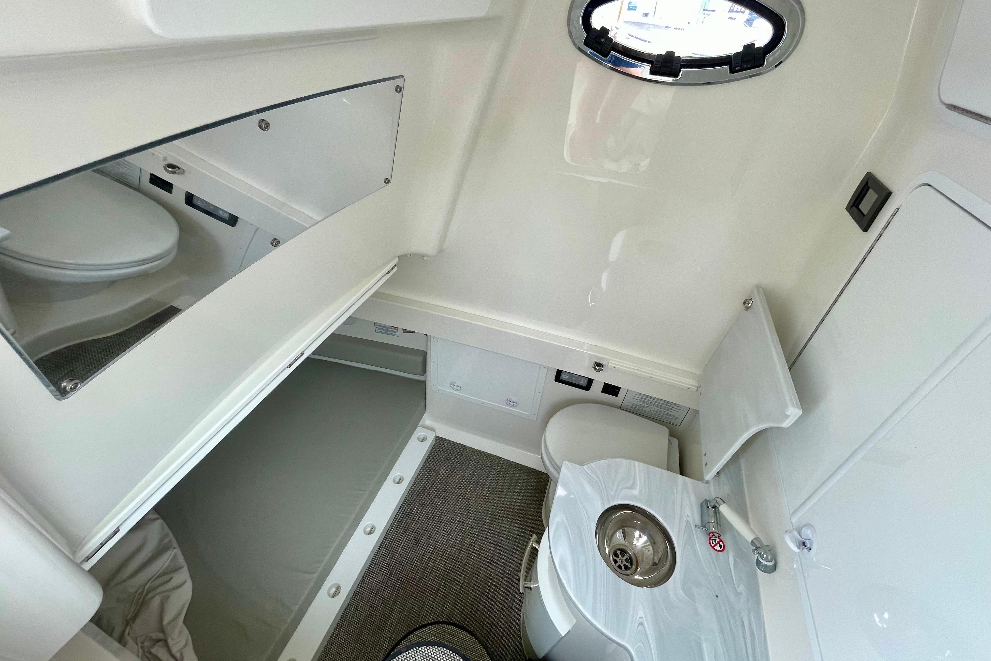 2023 Regulator 34 boat interior with compact bathroom and sink.