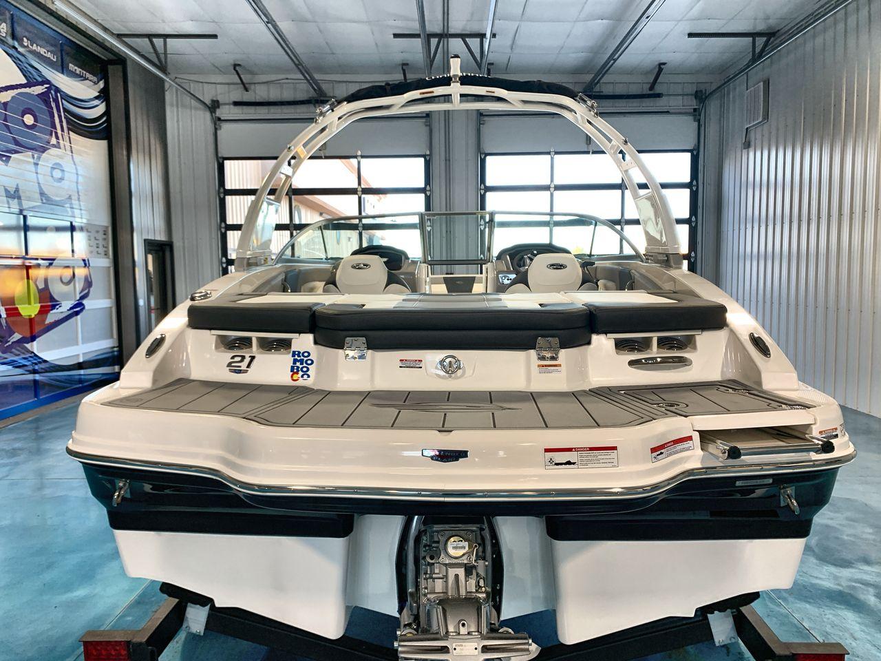 2025 Chaparral 21 SSi boat in showroom, rear view, sleek design.