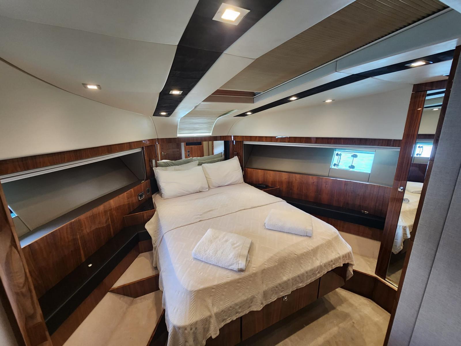 Luxurious cabin interior of 2012 Fairline Squadron 65 yacht with elegant wood finishes.