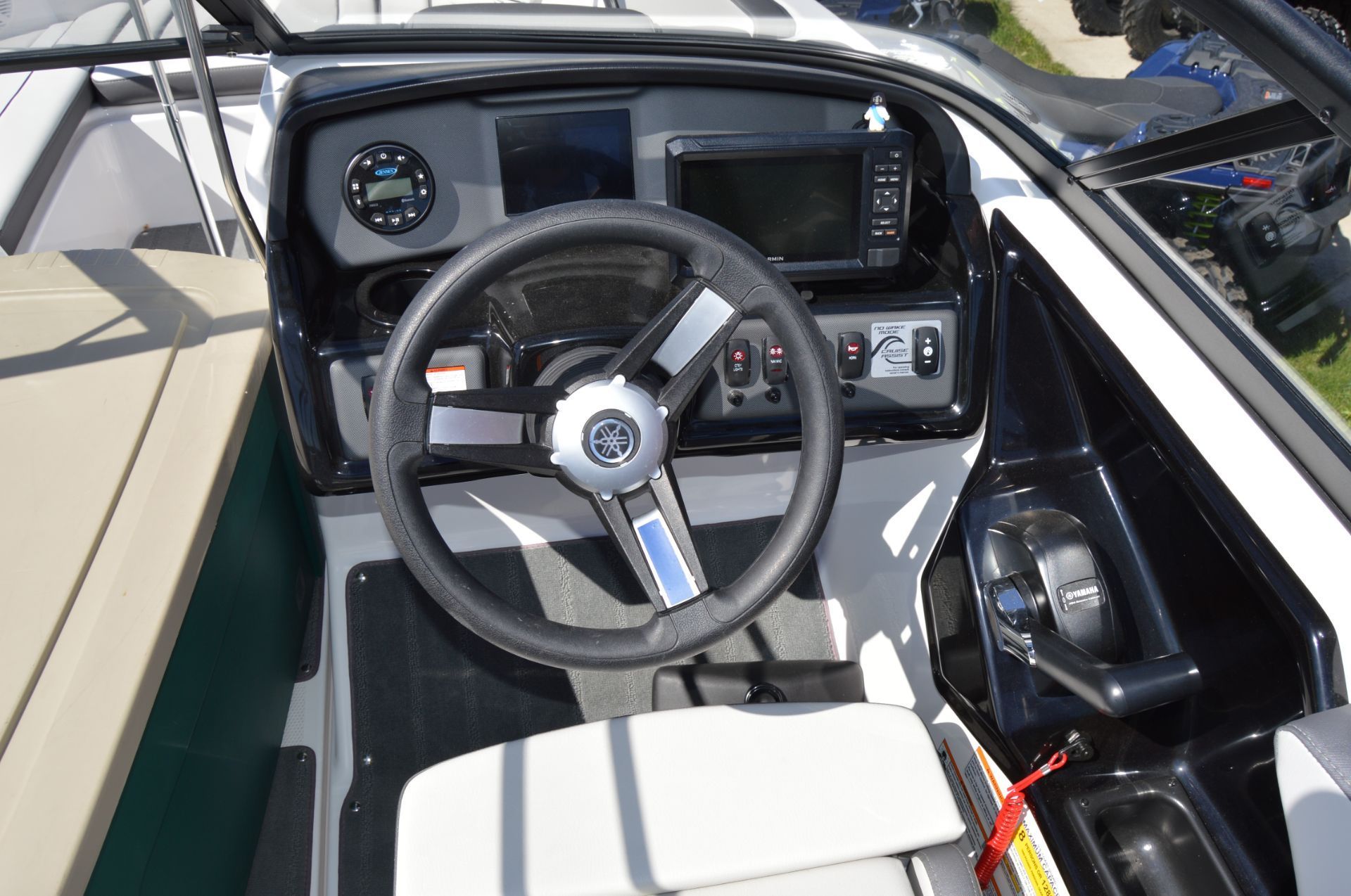 The image shows the cockpit of a Yamaha SX190 boat with a steering wheel and dashboard.