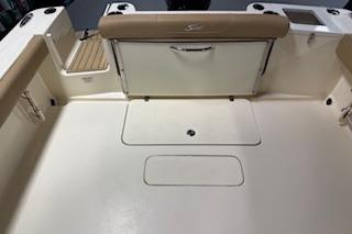 2021 Scout 215 Dorado boat interior with beige seating and storage compartments.