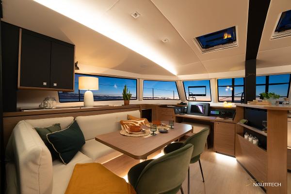 Luxurious interior of 2025 Nautitech 48 Open catamaran with modern furnishings and panoramic windows.