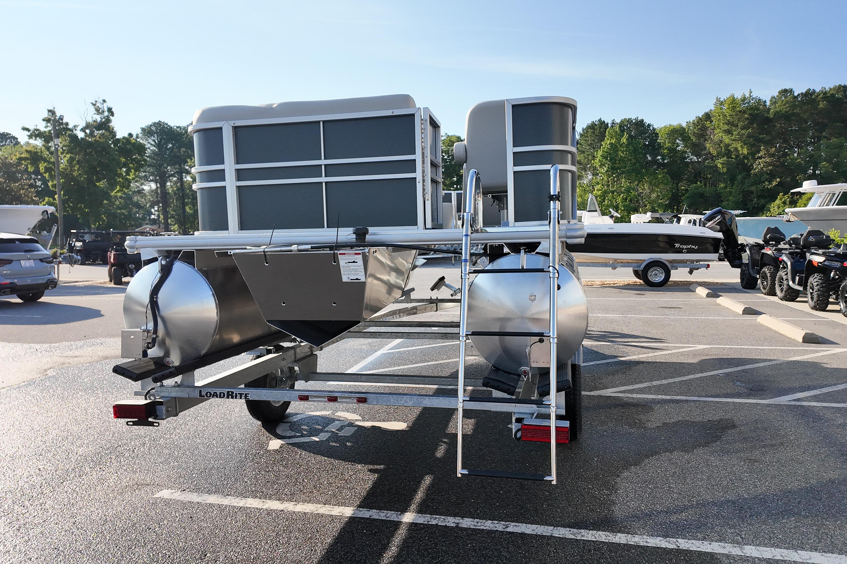 2026 Sylvan Mirage 818 Fish pontoon boat on trailer in parking lot.