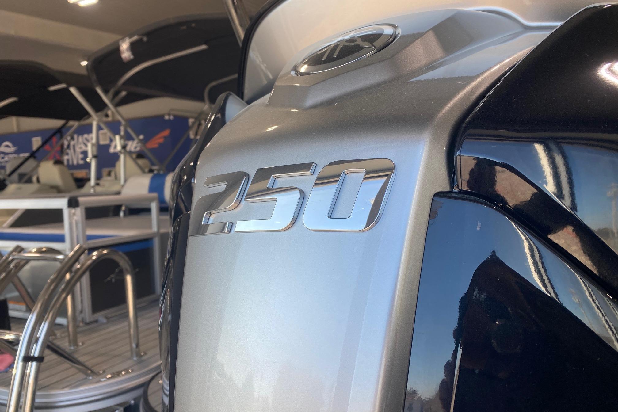 Close-up of 2026 SunCatcher Fusion 324SS boat engine with "250" emblem.