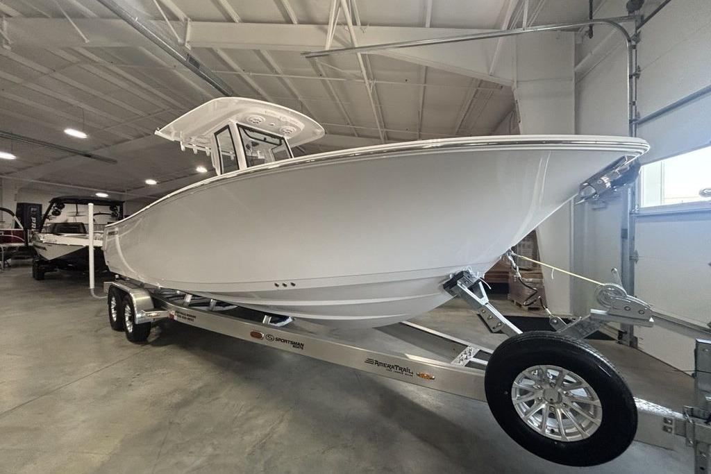 2026 Sportsman Open 252 Center Console boat on trailer in indoor showroom.