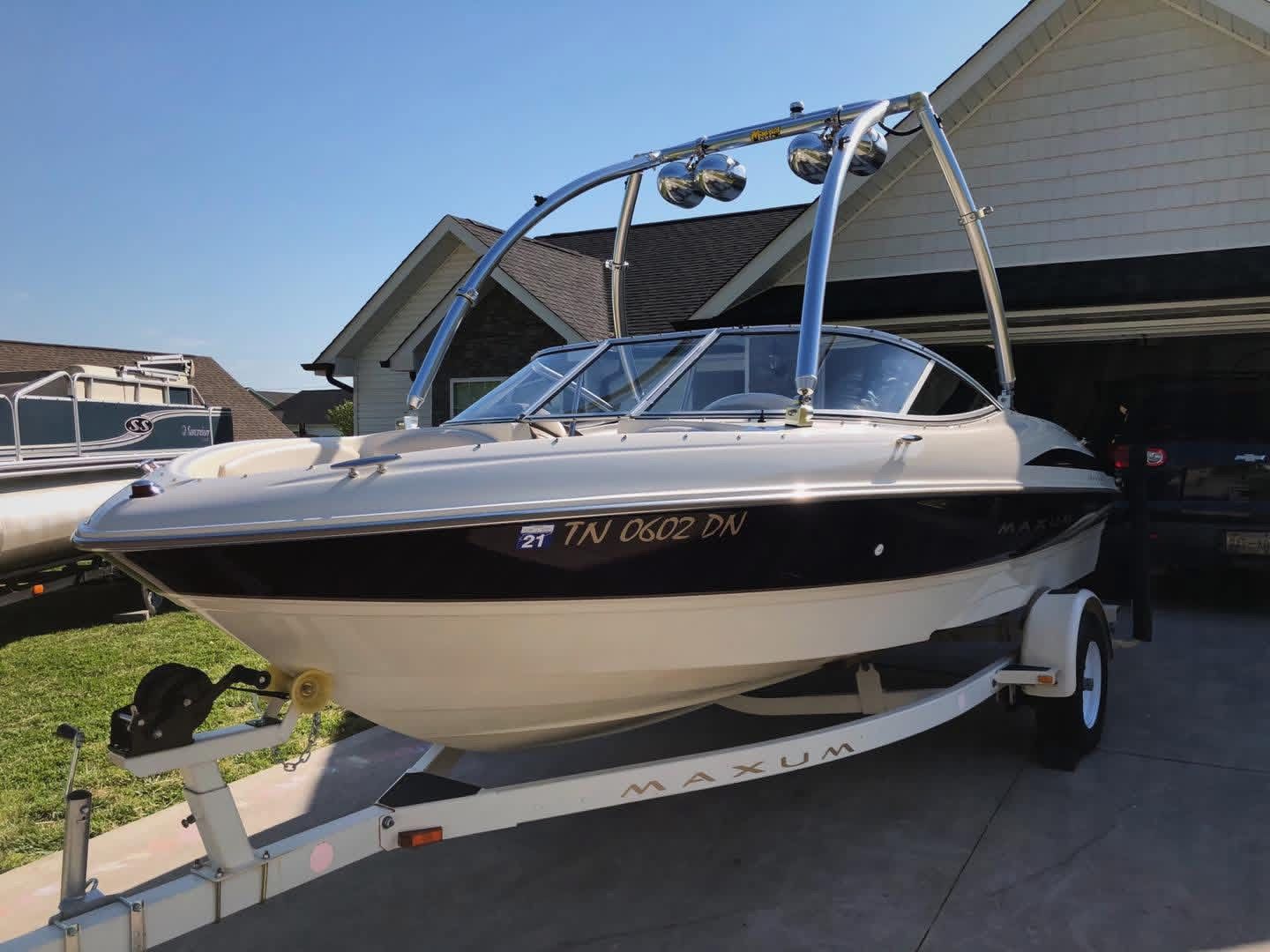 1999 Maxum 1800 SR boat on trailer in front of garage.