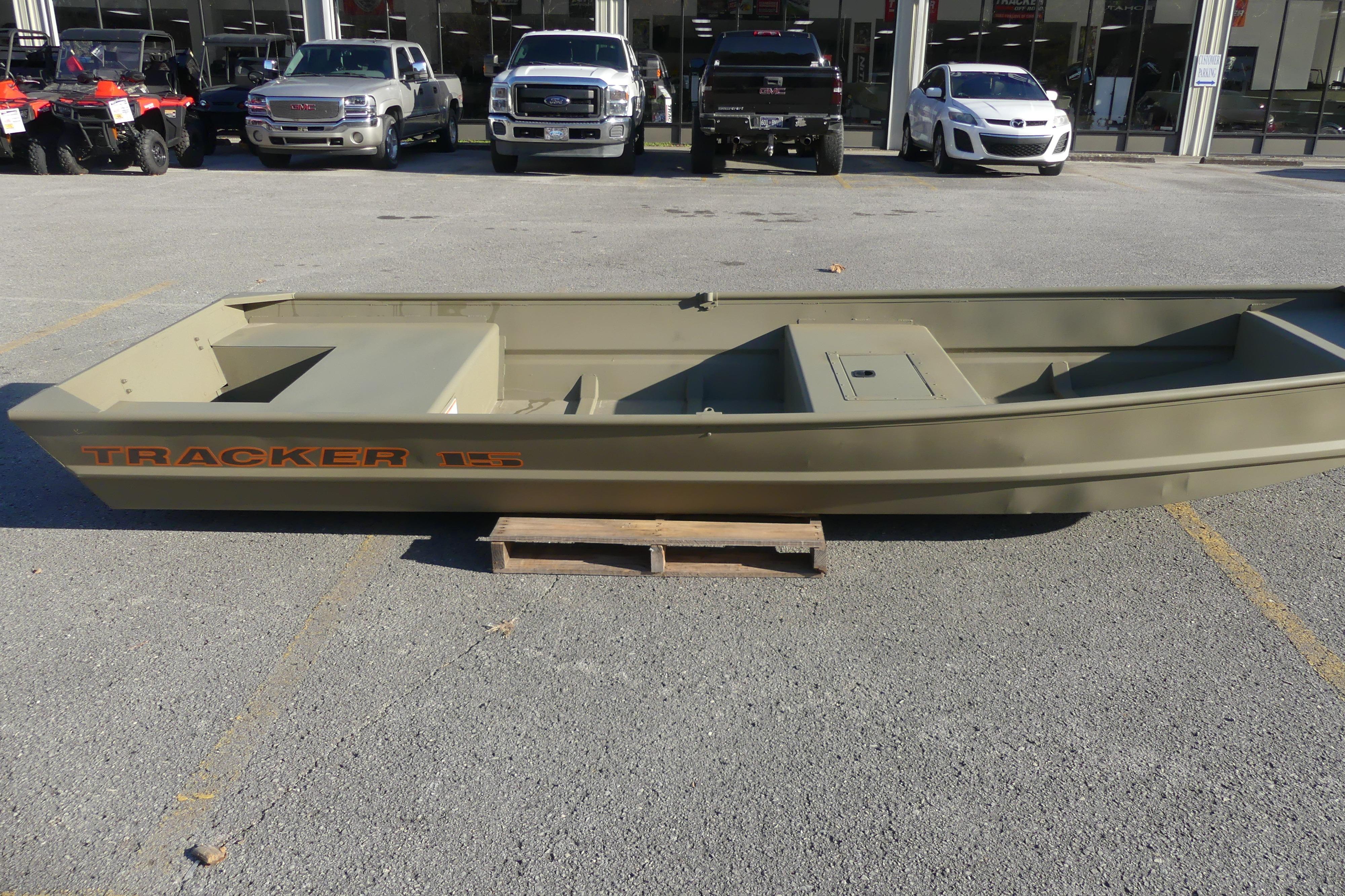 2026 Tracker Grizzly 15 Jon boat displayed outdoors on a wooden pallet.