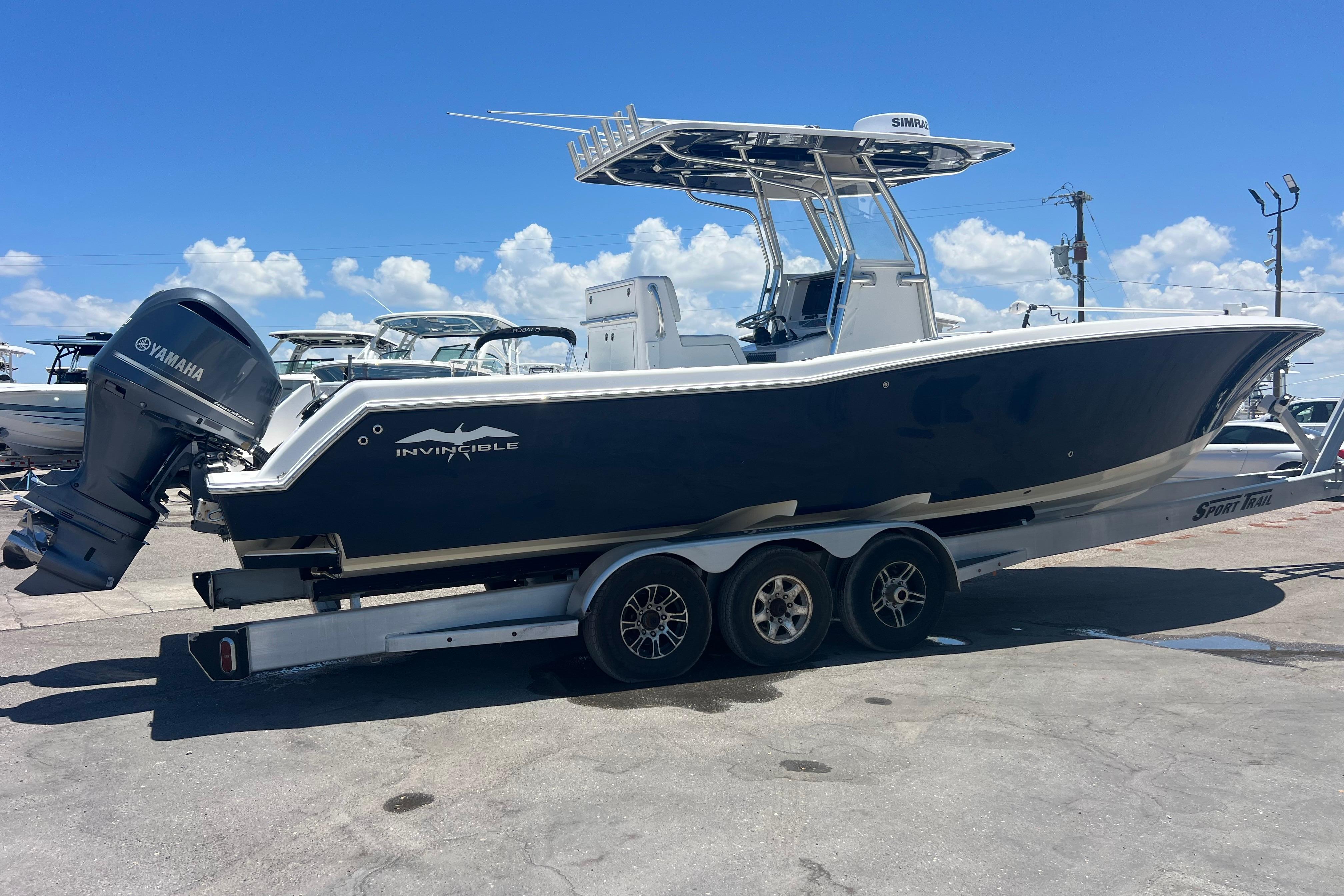 2012 Invincible 33 Open Fisherman boat on trailer with Yamaha outboard motor.