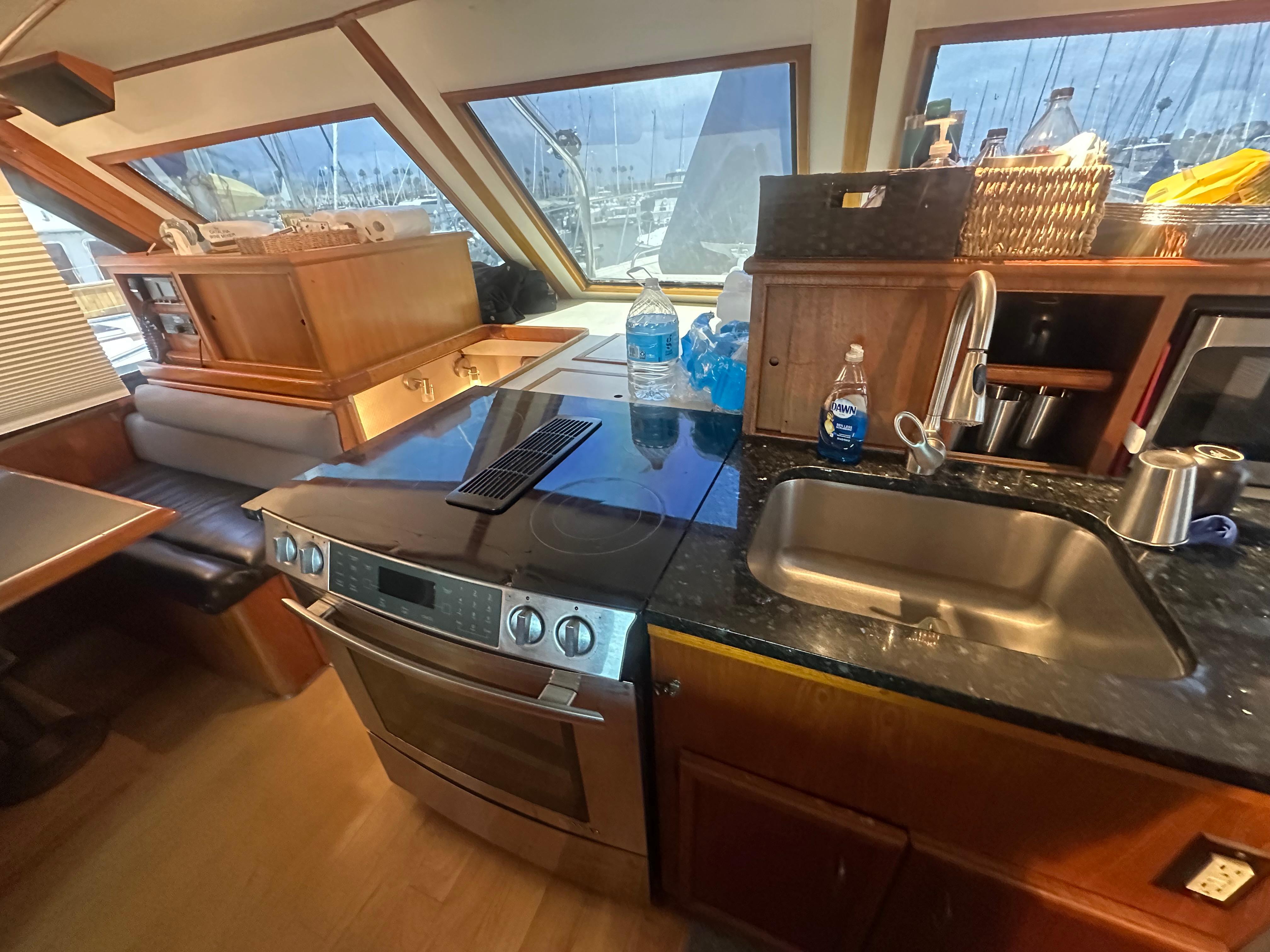 1986 Egg Harbor SPORT FISHER yacht kitchen with modern appliances and wooden cabinetry.