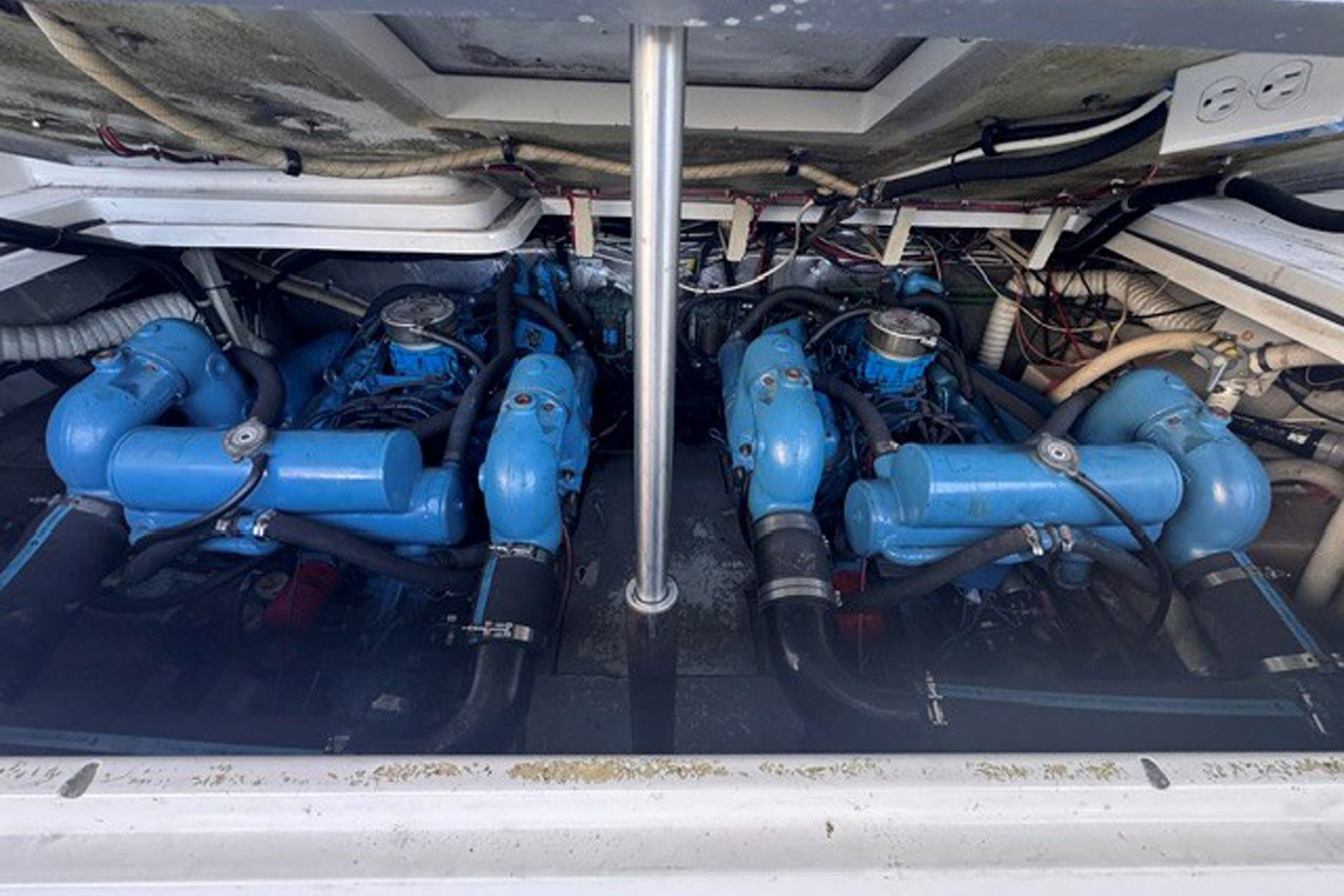 Engine compartment of a 1988 Tiara Yachts 3300 Open, featuring dual blue engines.