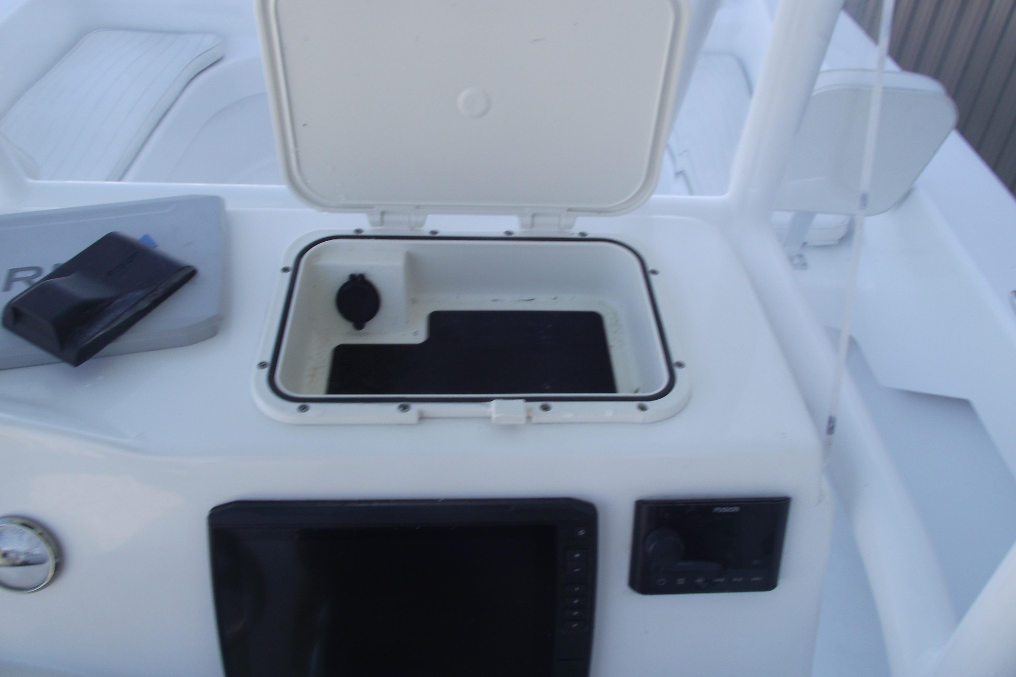2021 Savannah SS21 boat console with open storage compartment and electronic controls.