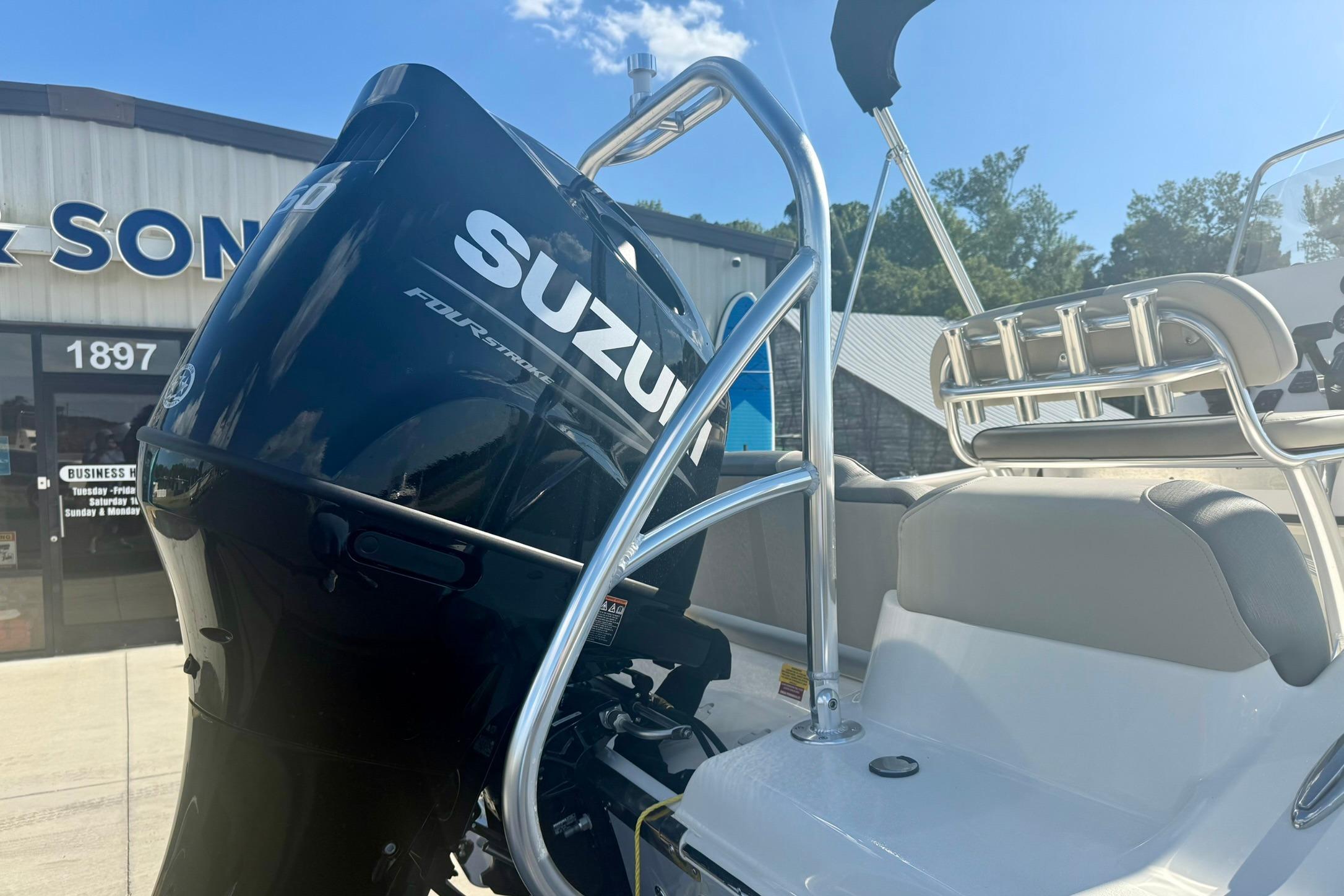 2026 Key West 189 FS boat with Suzuki outboard motor, parked outside a dealership.