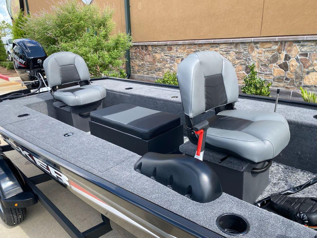 2025 Tracker Panfish 17 boat interior with two gray seats and a Mercury outboard motor.