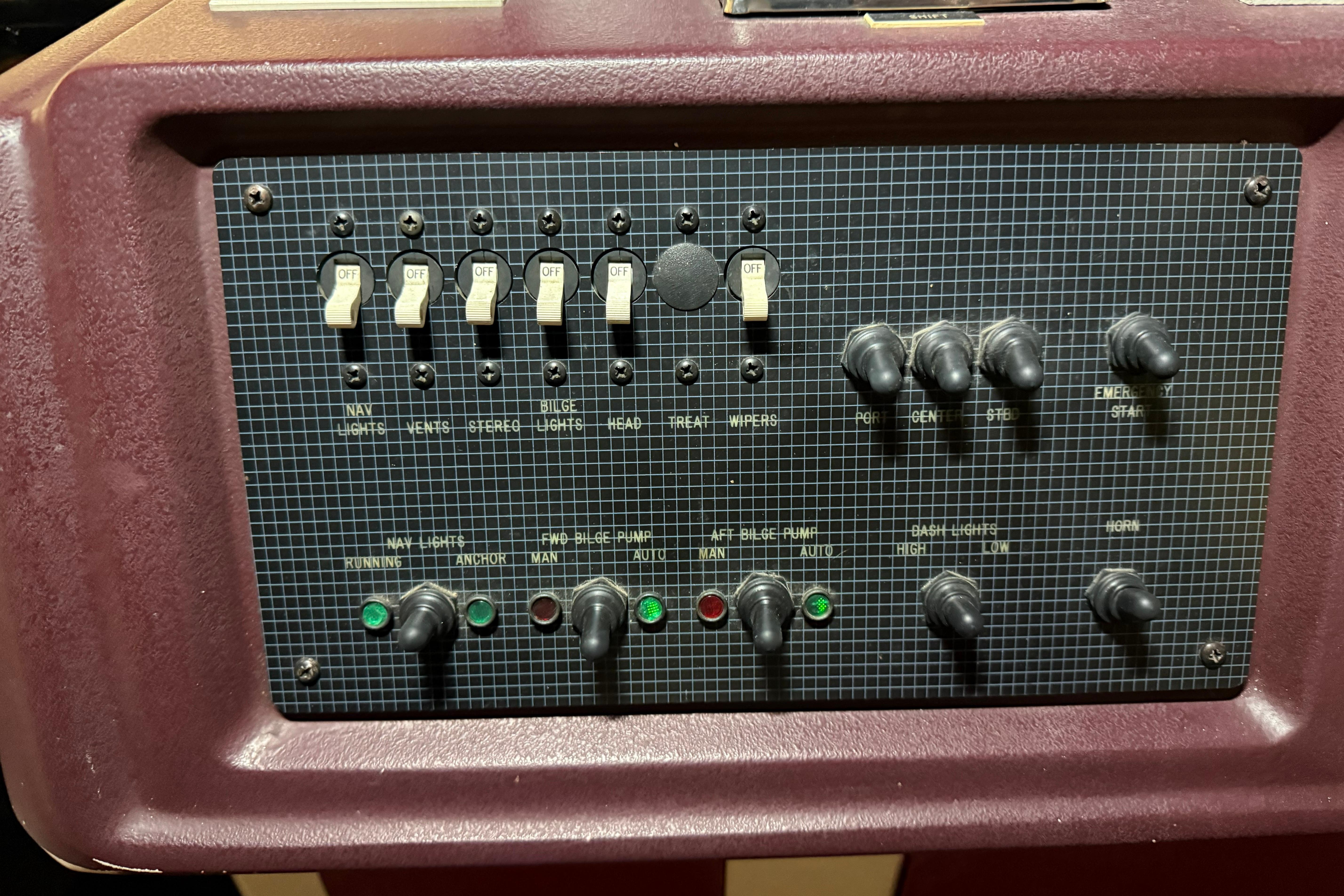 Control panel of a 1989 Sea Ray 340 Express Cruiser with switches and indicators.