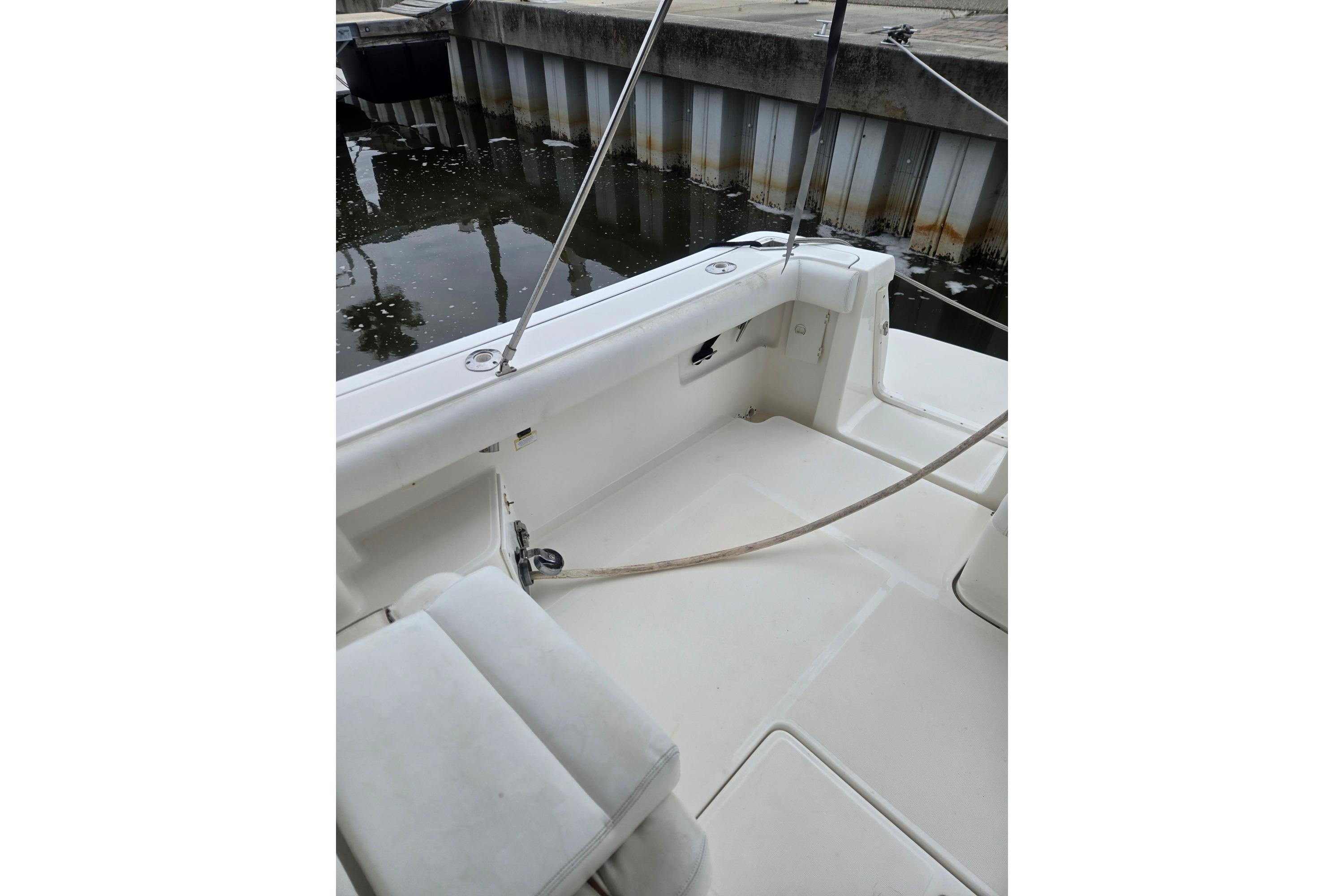 2002 Tiara Yachts 3500 Open boat deck, docked by a marina.