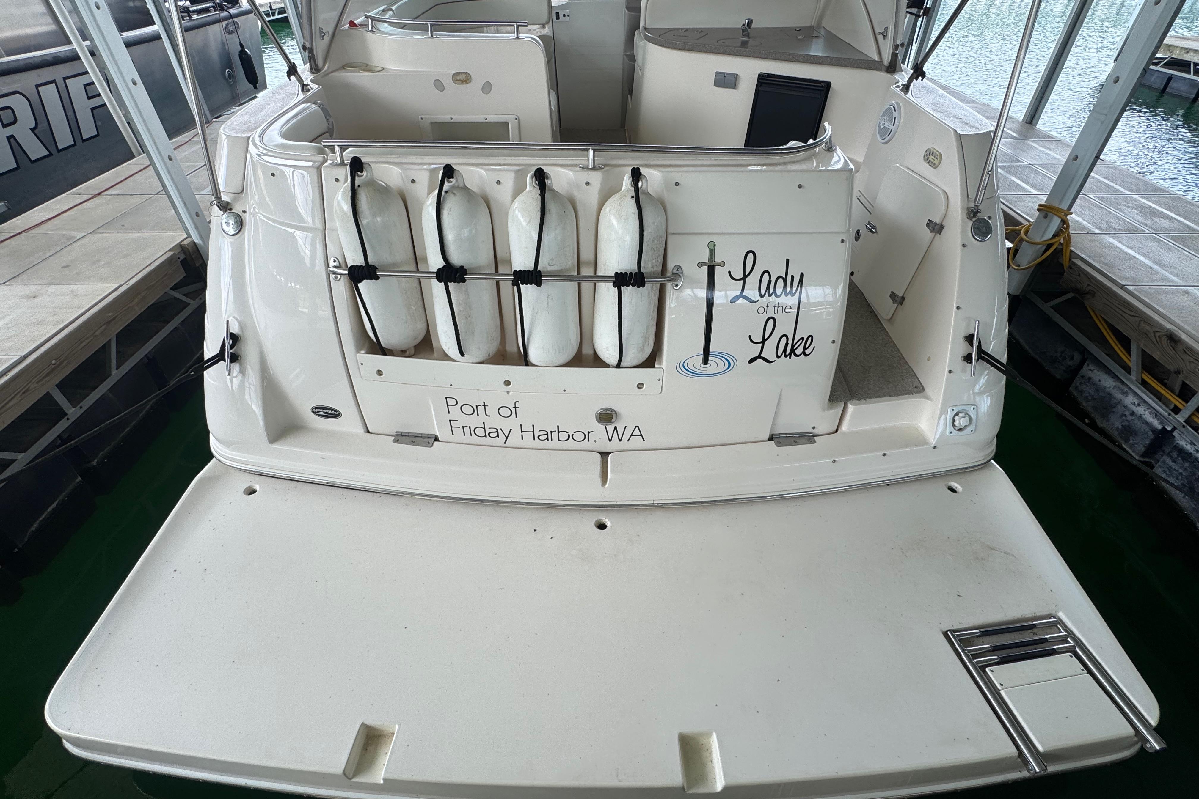 2004 Rinker Fiesta Vee 312 boat docked, featuring "Lady of the Lake" name and fenders.
