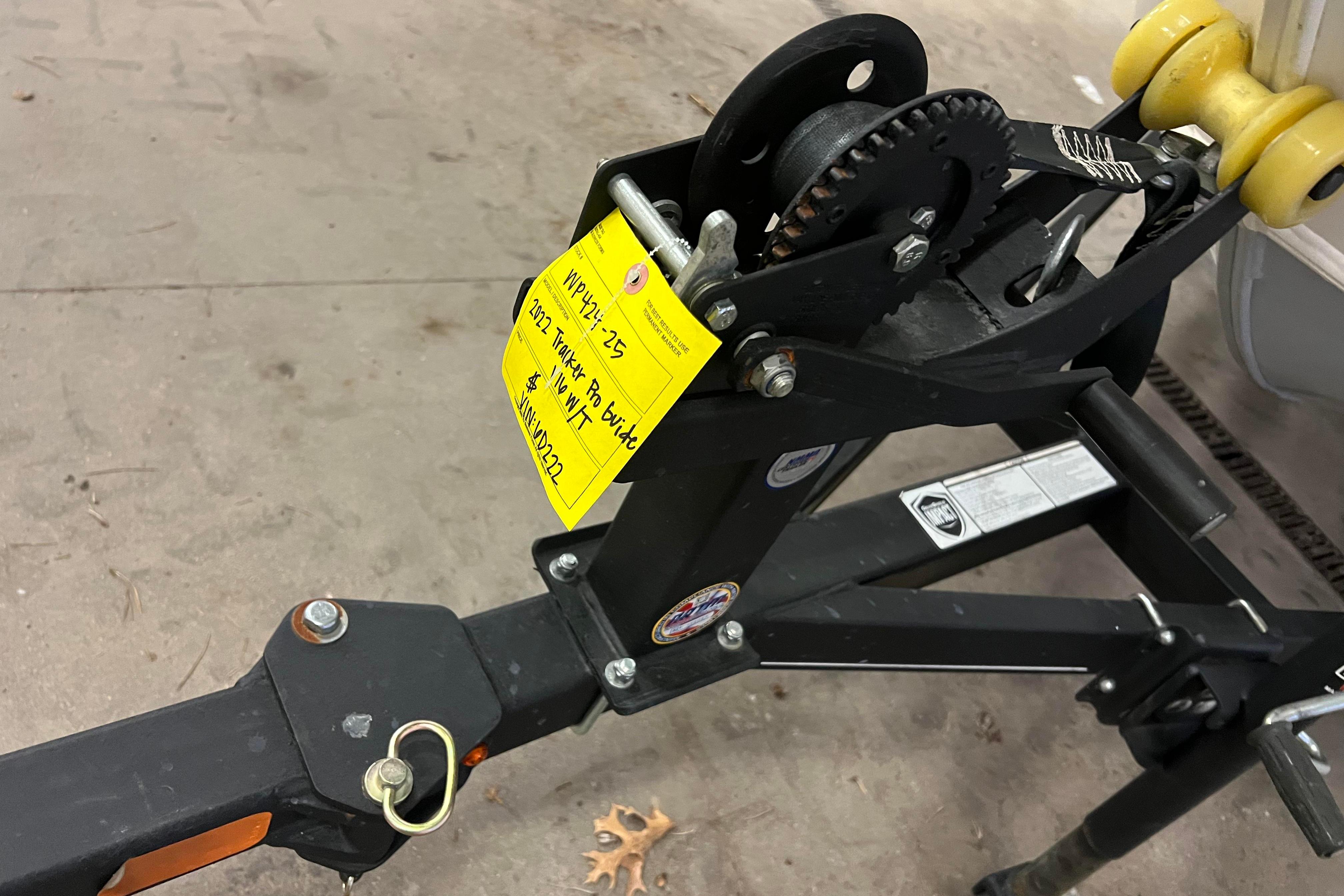Trailer hitch of 2022 Tracker Pro Guide V-16 WT with yellow tag attached.