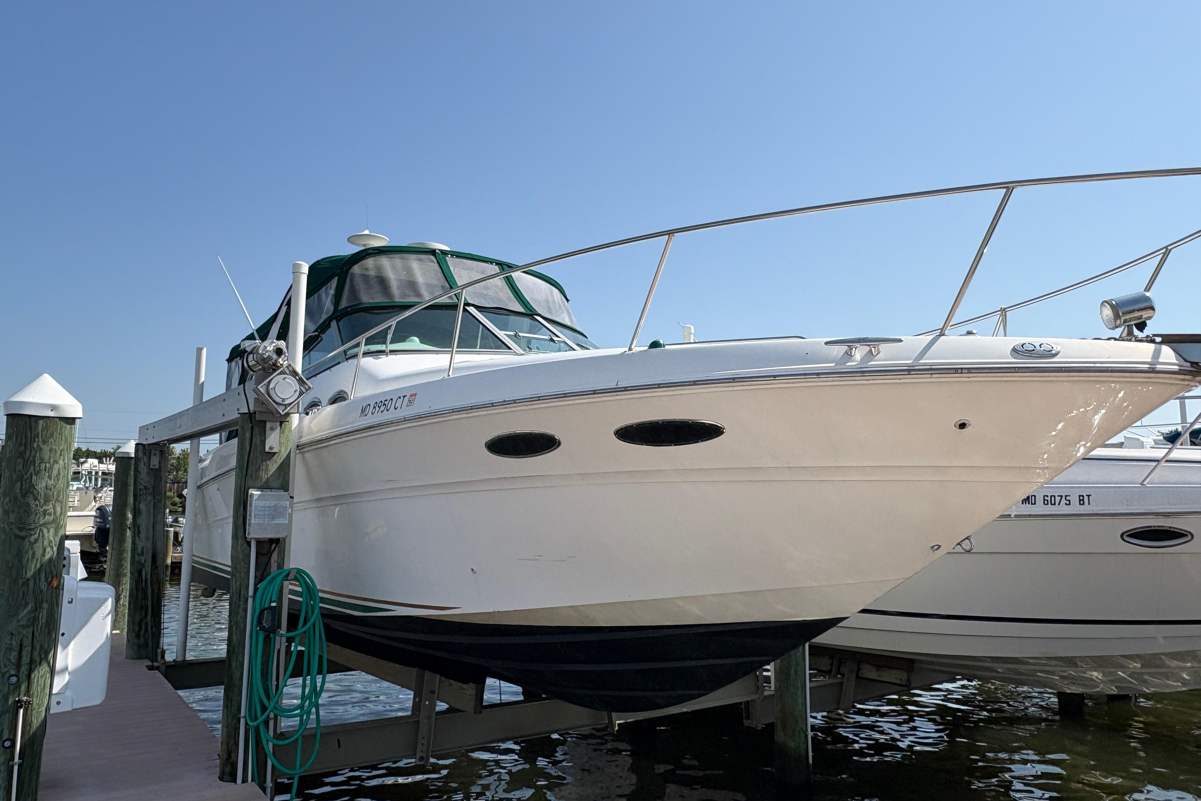 2001 Sea Ray Sundancer 310 boat docked, featuring sleek design and white exterior.