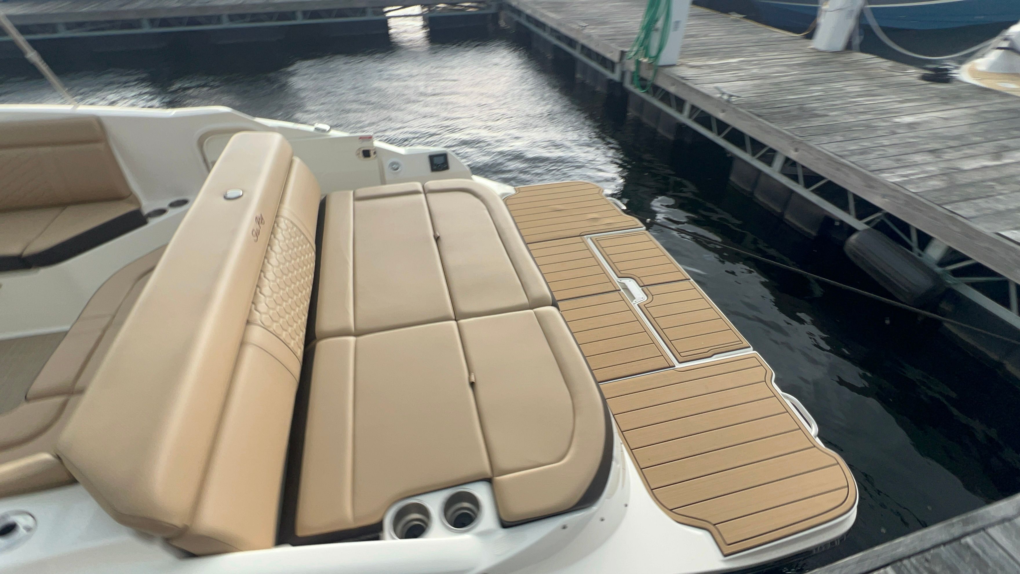 2018 Sea Ray SDX 270 boat at dock with lounging area.