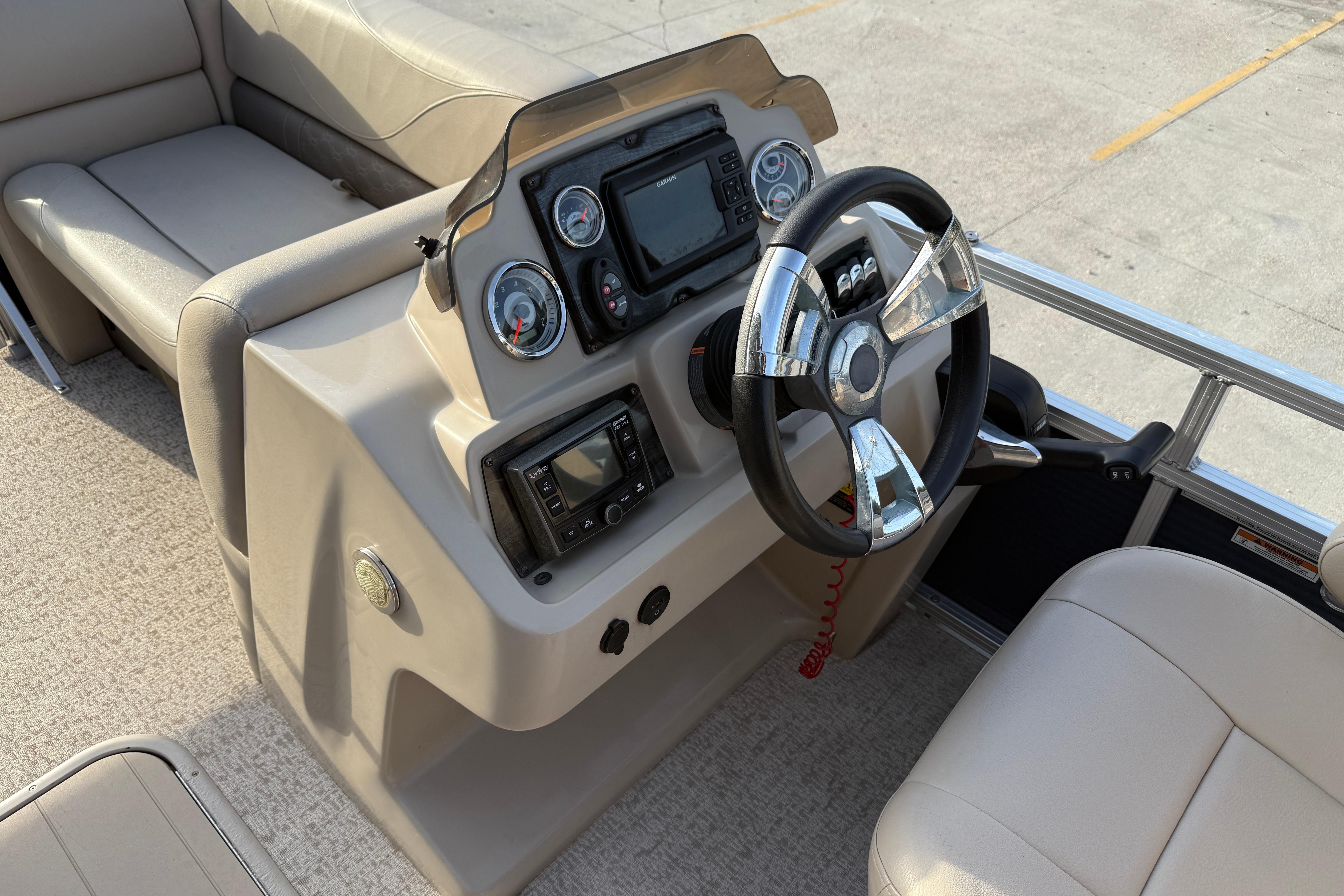 2019 Avalon Venture Fish N Cruise boat dashboard with steering wheel and controls.