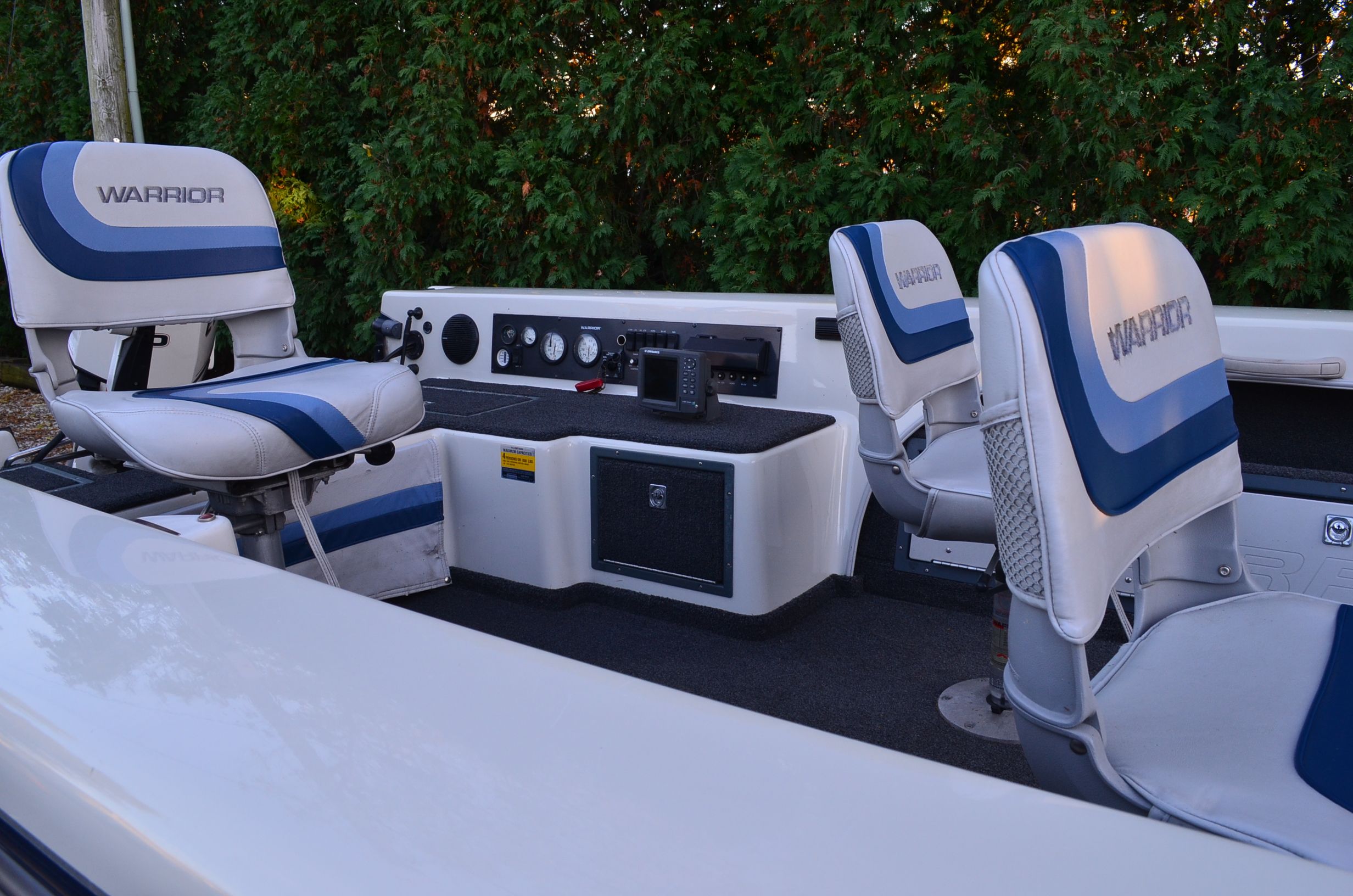 The image shows the cockpit of a 2000 Warrior V1890 Backtroller Eagle with blue and white seats.