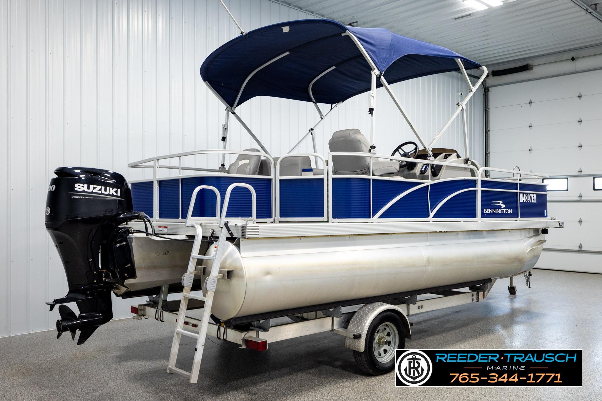2021 Bennington 20 SV pontoon boat with Suzuki engine in indoor showroom.