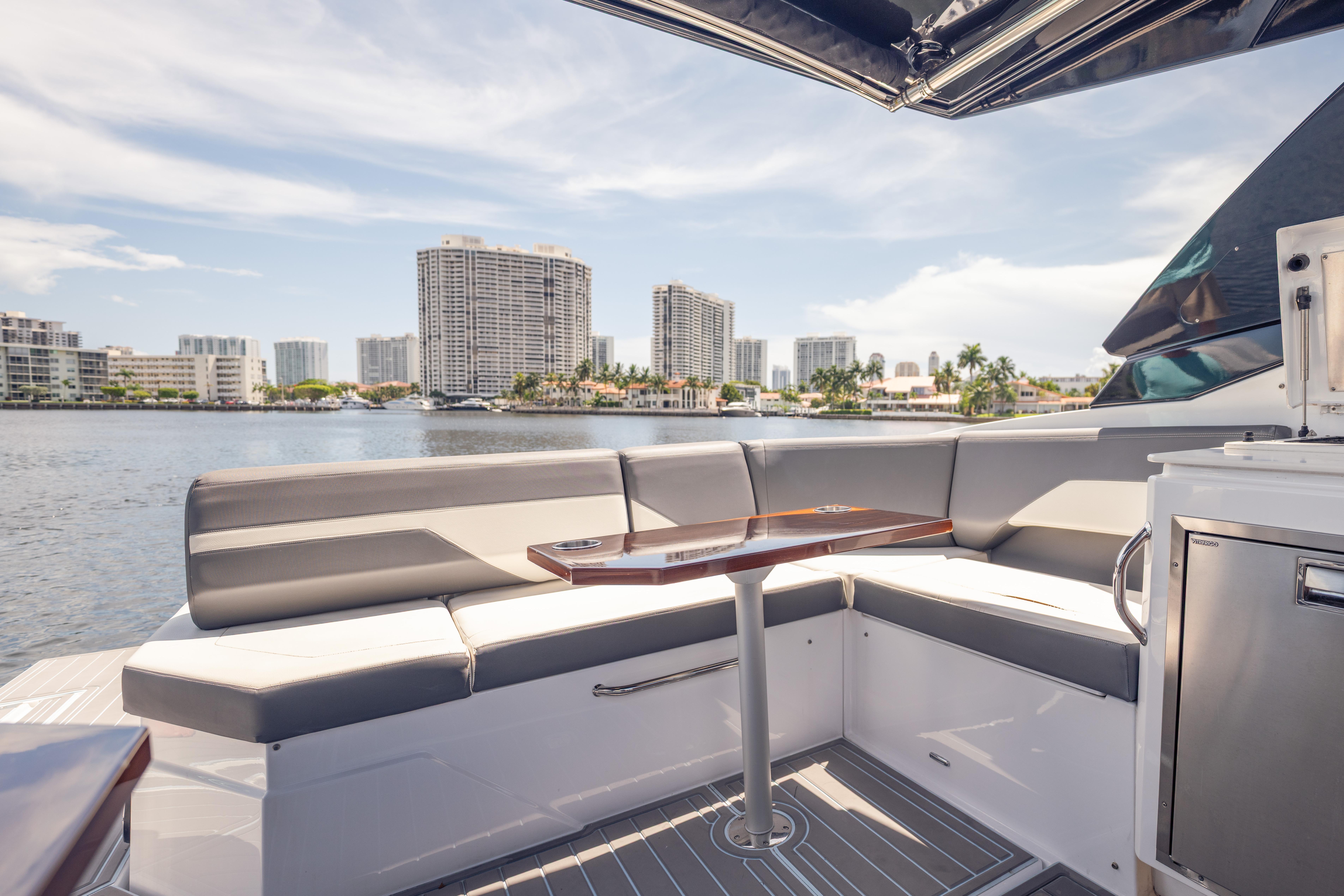 Luxurious 2021 Cruisers Yachts 38 GLS interior with waterfront cityscape view.