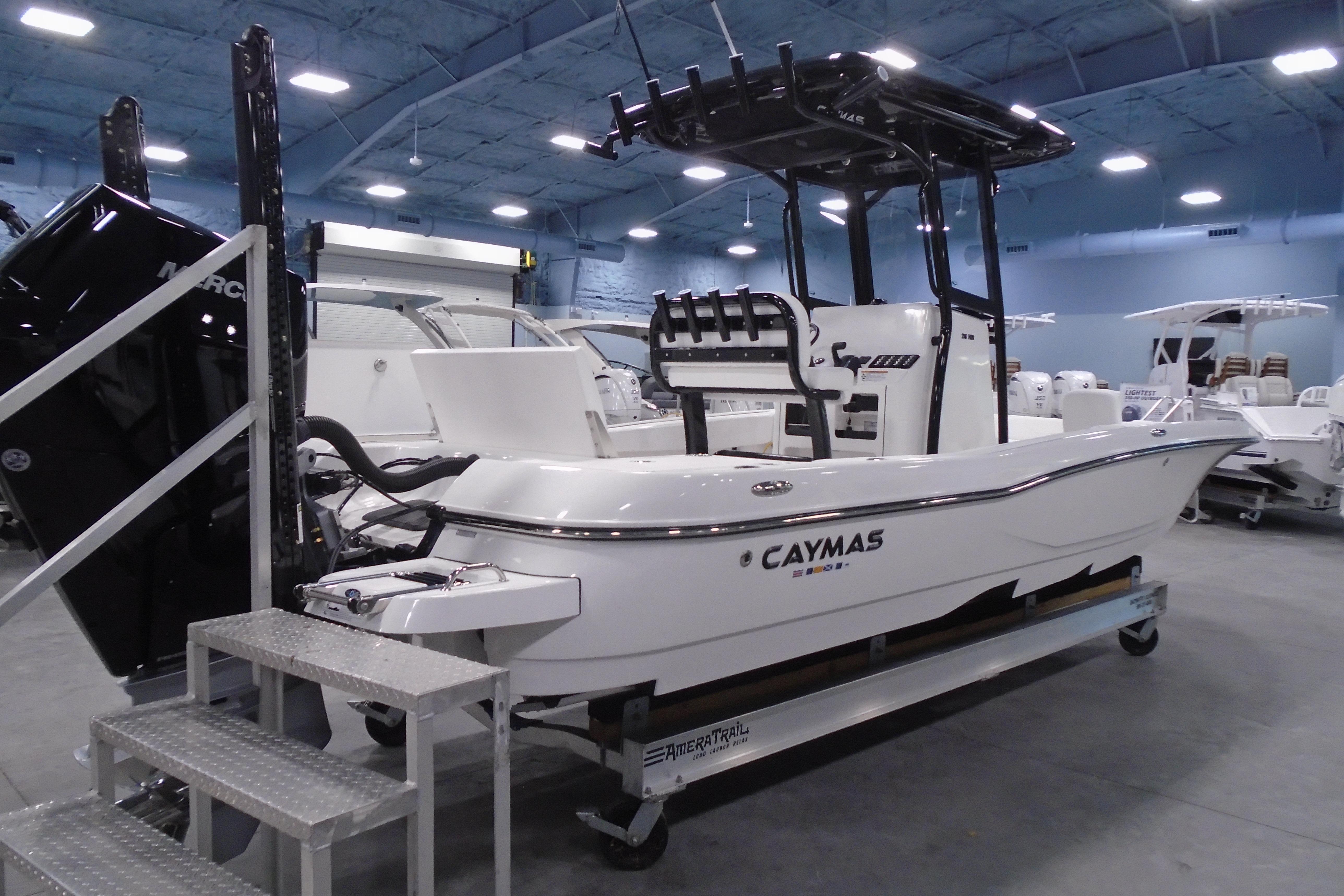 2026 Caymas 26 HB boat displayed indoors, featuring sleek design and modern equipment.